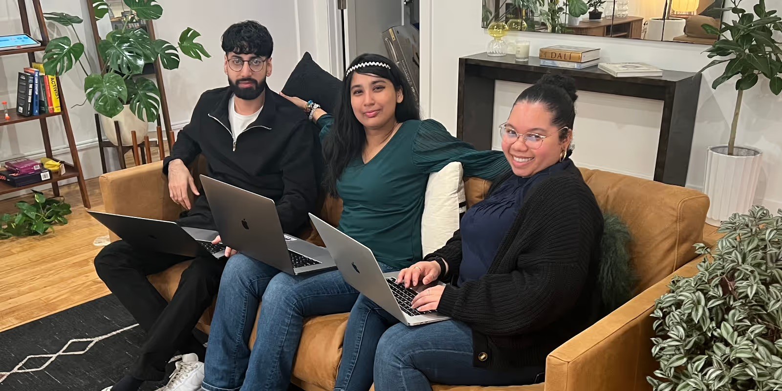 Clair team members relaxing together on a sofa in the office