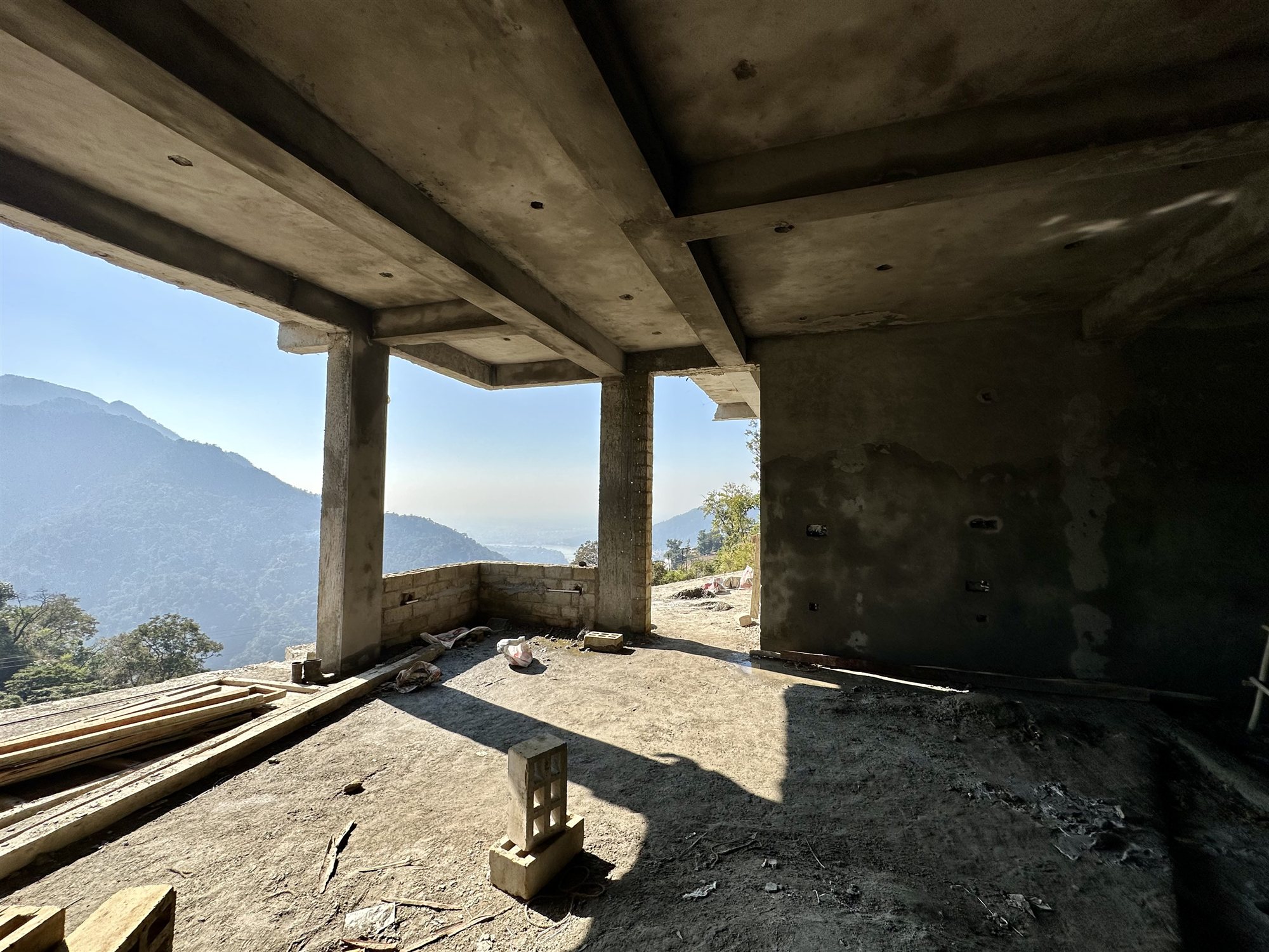 Open upper floor of the Rishikesh home looking out to the mountains