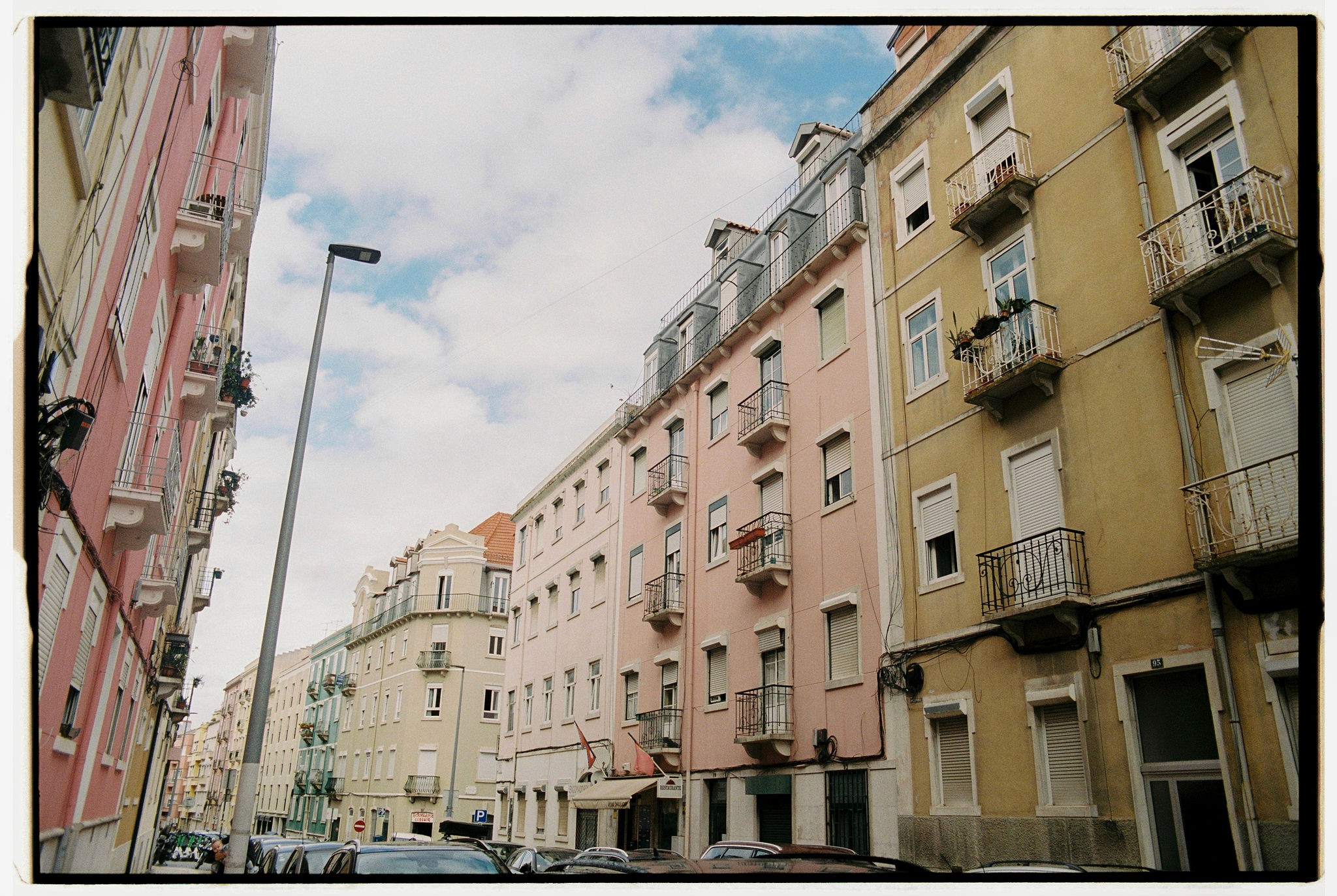 Modern skyscrapers line a busy highway in a sprawling city.