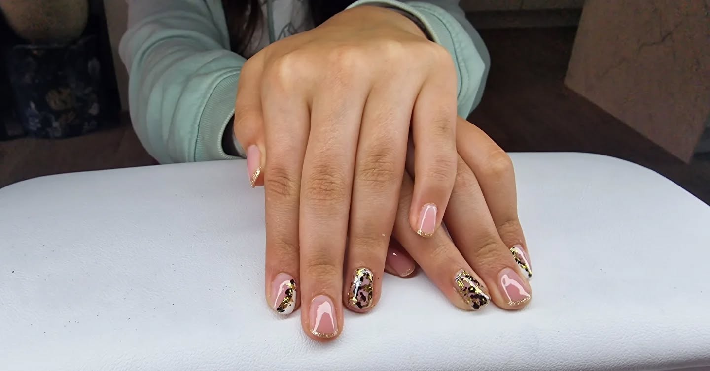 Hand with glittery pastel nails in sunlight