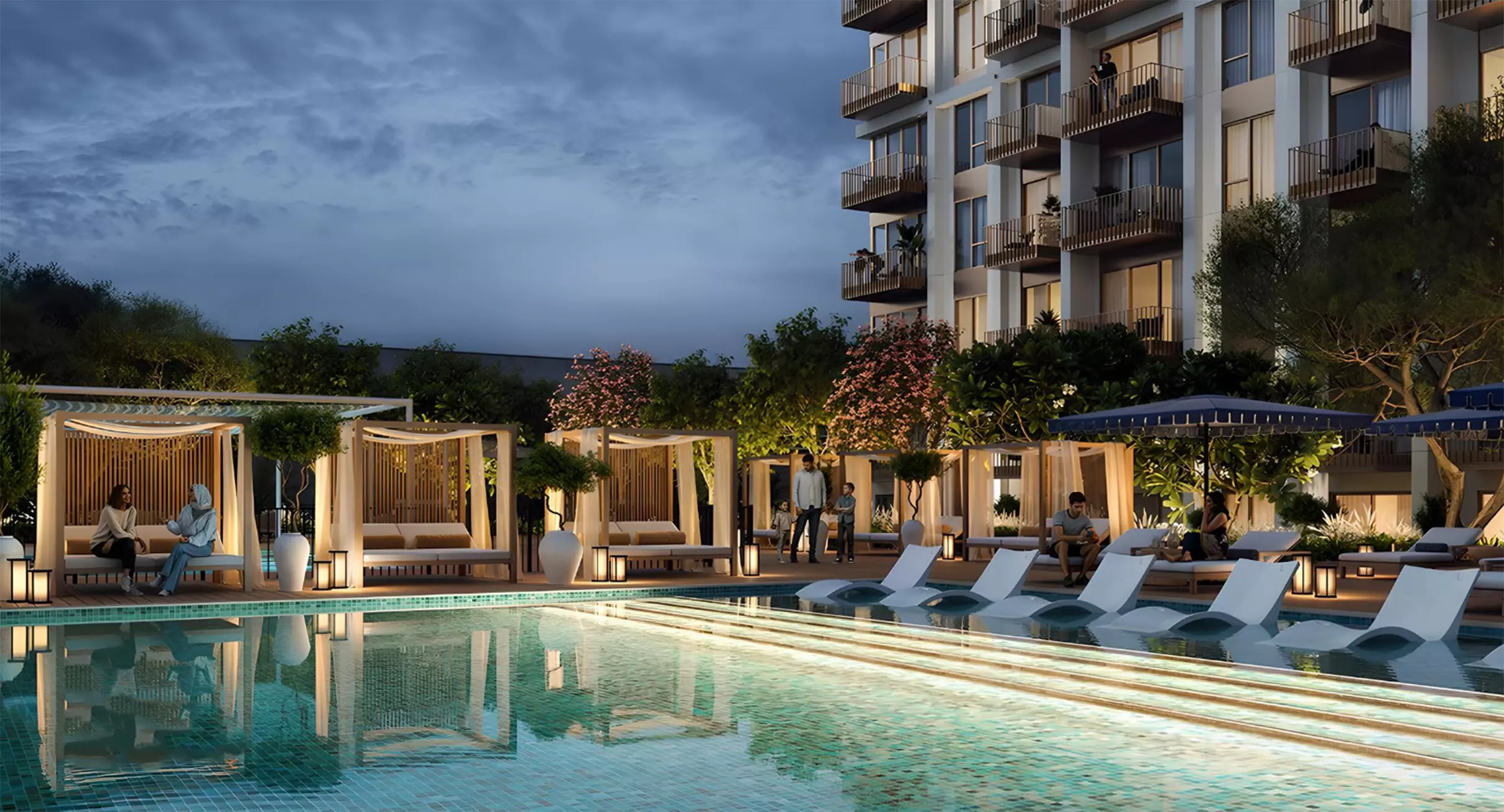 Poolside cabanas and illuminated evening atmosphere at Emaar Altus residential complex in Dubai.