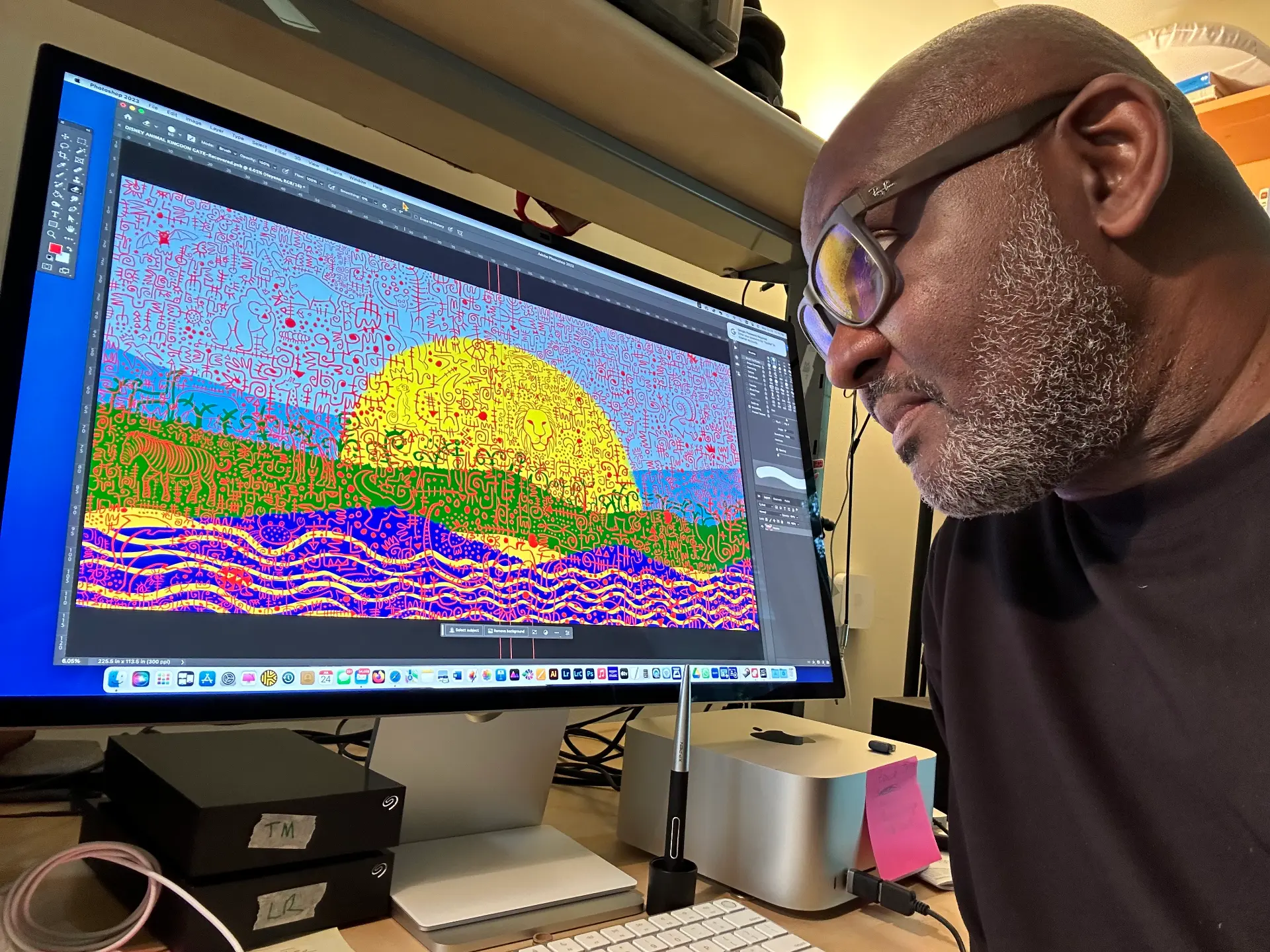 Victor Ekpuk drawing mural for Disney World Animal Kingdom