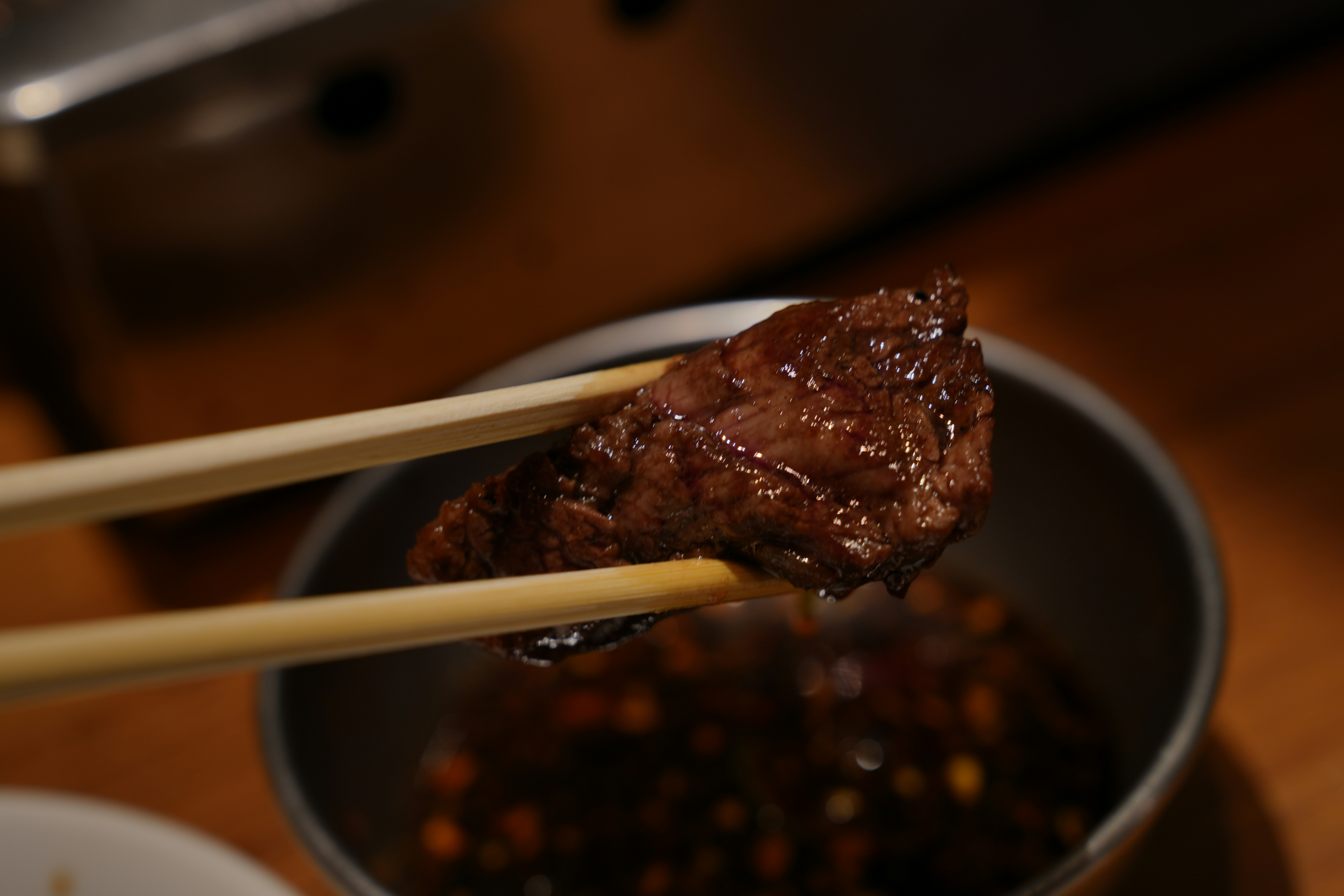 A close up of chopsticks in a bowl of food