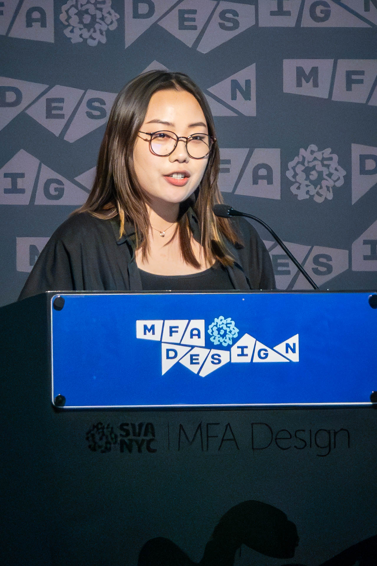 student at a podium giving a presentation