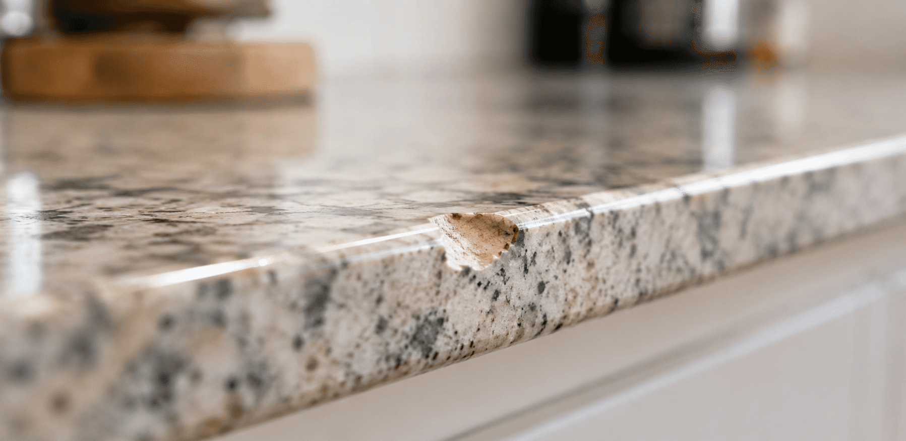 Hairline crack in a residential granite countertop before professional repair.