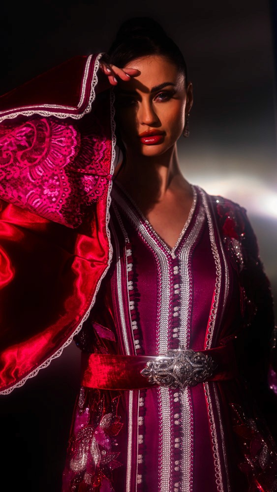 Fuchsia Moroccan caftan with sculptural sleeves and intricate embroidery, bold handcrafted couture piece in Bahrain