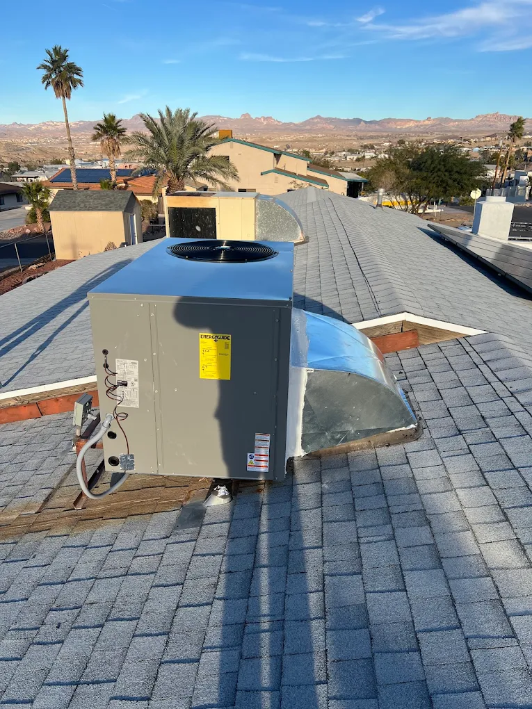 Air Time technician repairing an air conditioner at a house in Mohave Valley, AZ