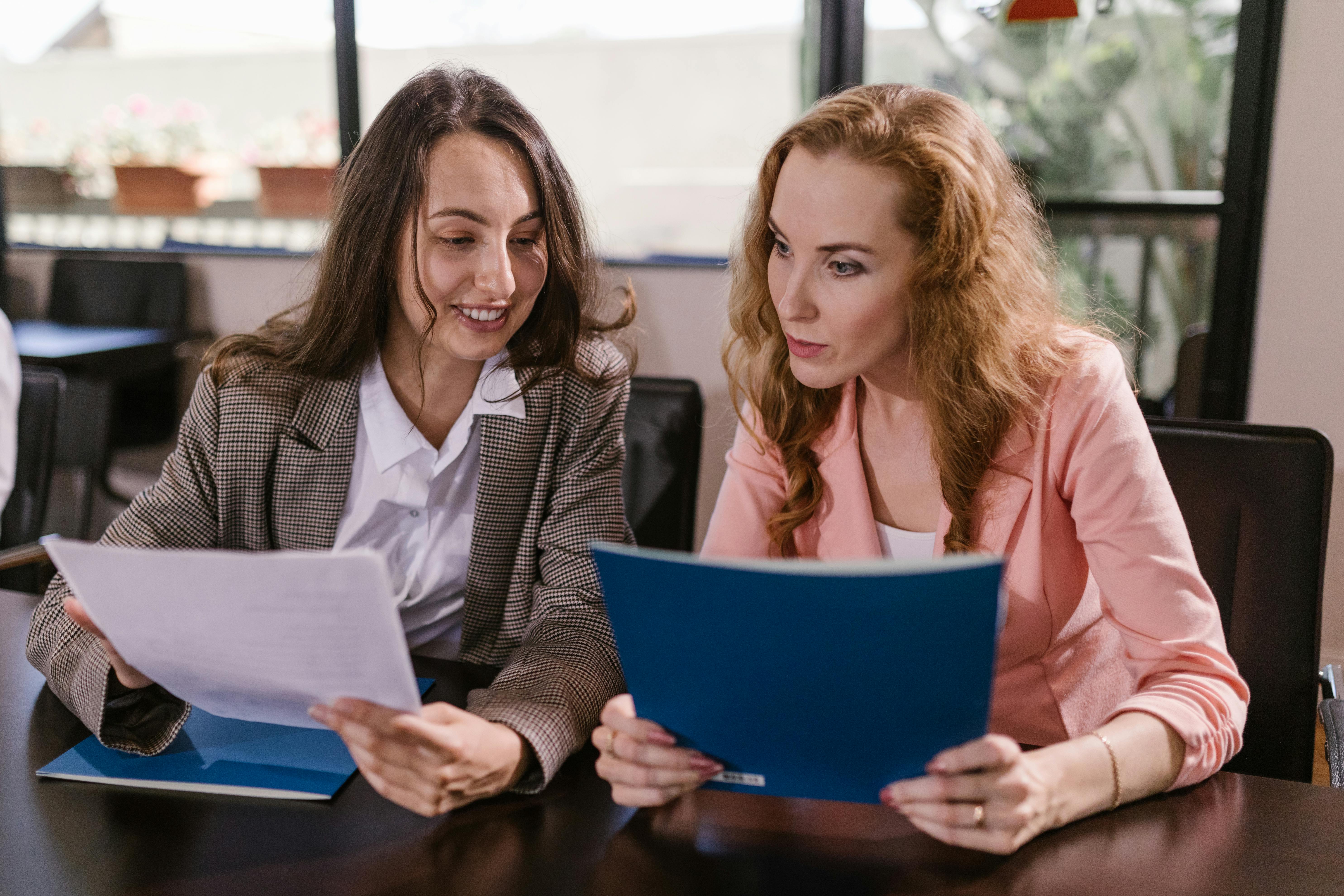 Broker and buying agent looking at documents