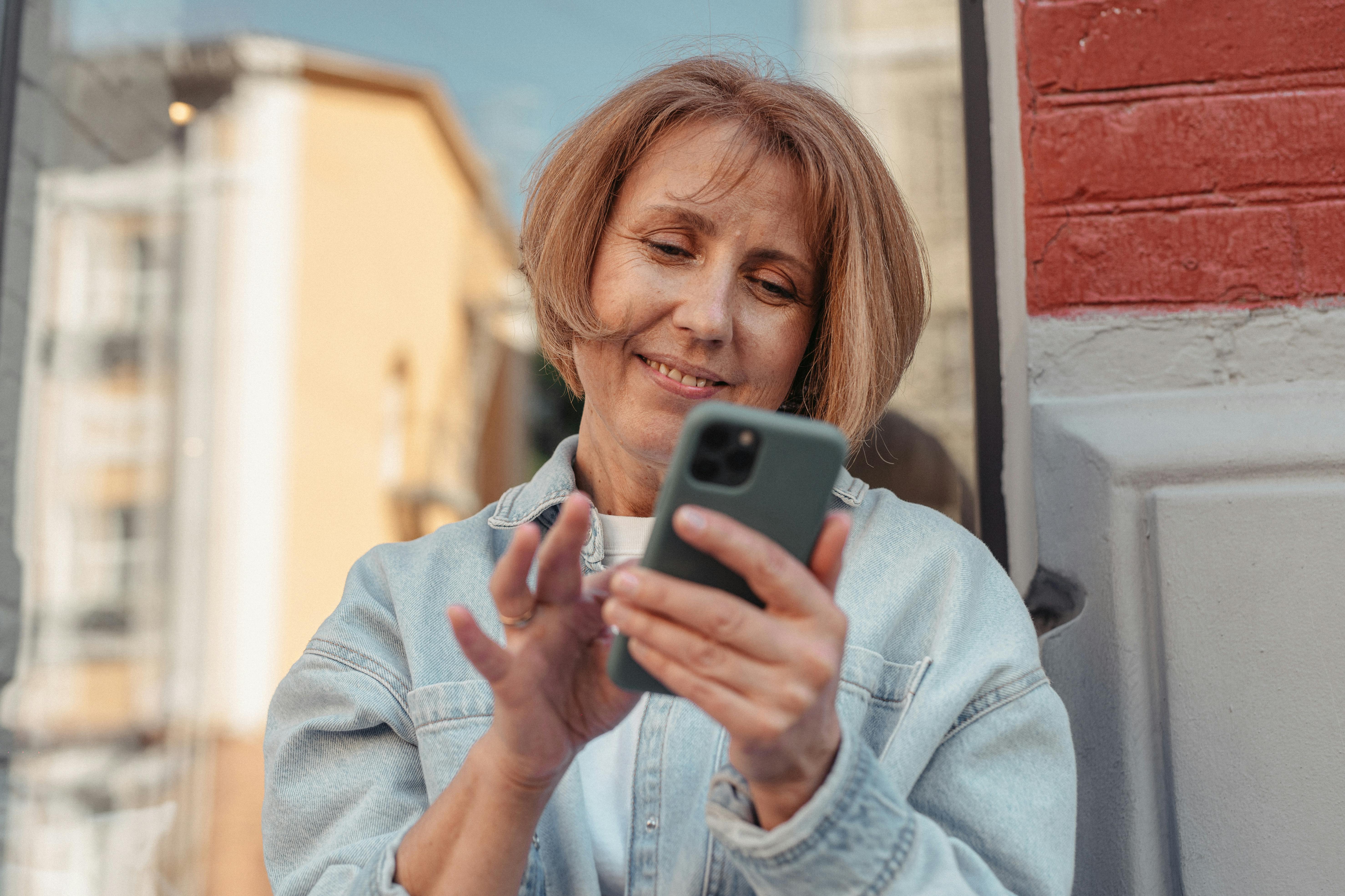 Man talking animatedly on the phone while sitting on couch.