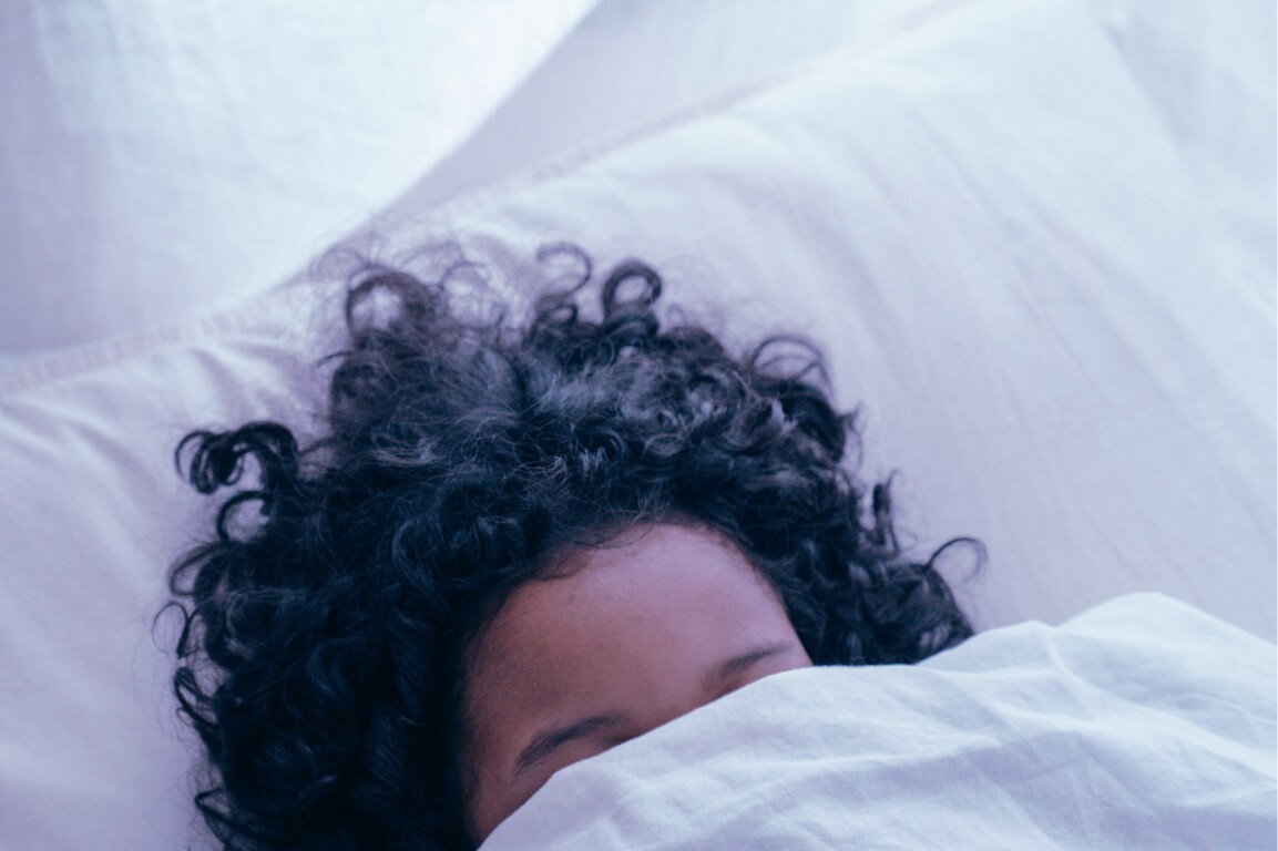 Black woman with curly hair white sheets white pillow bed sleep sleeping narcolepsy