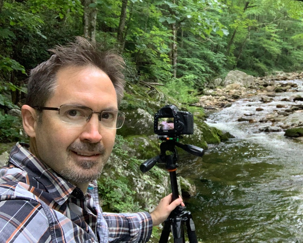 Andrew Aveling photographing a river.