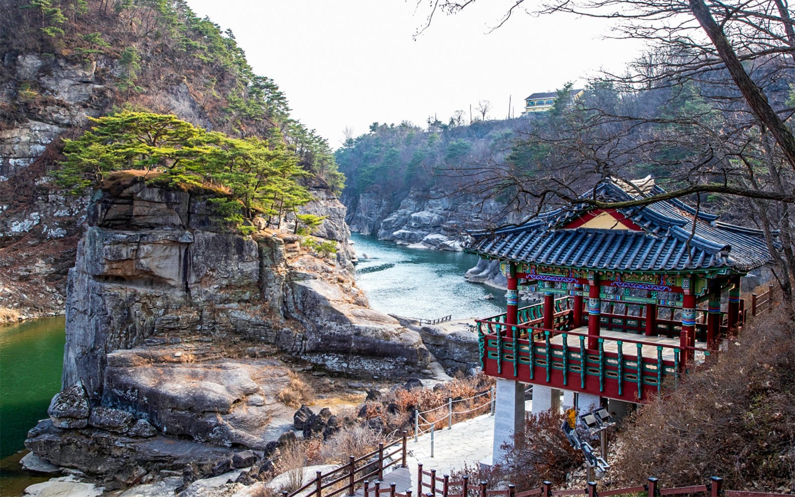 Traditional Korean pavilion overlooking rocky cliffs and river in Paju DMZ area.