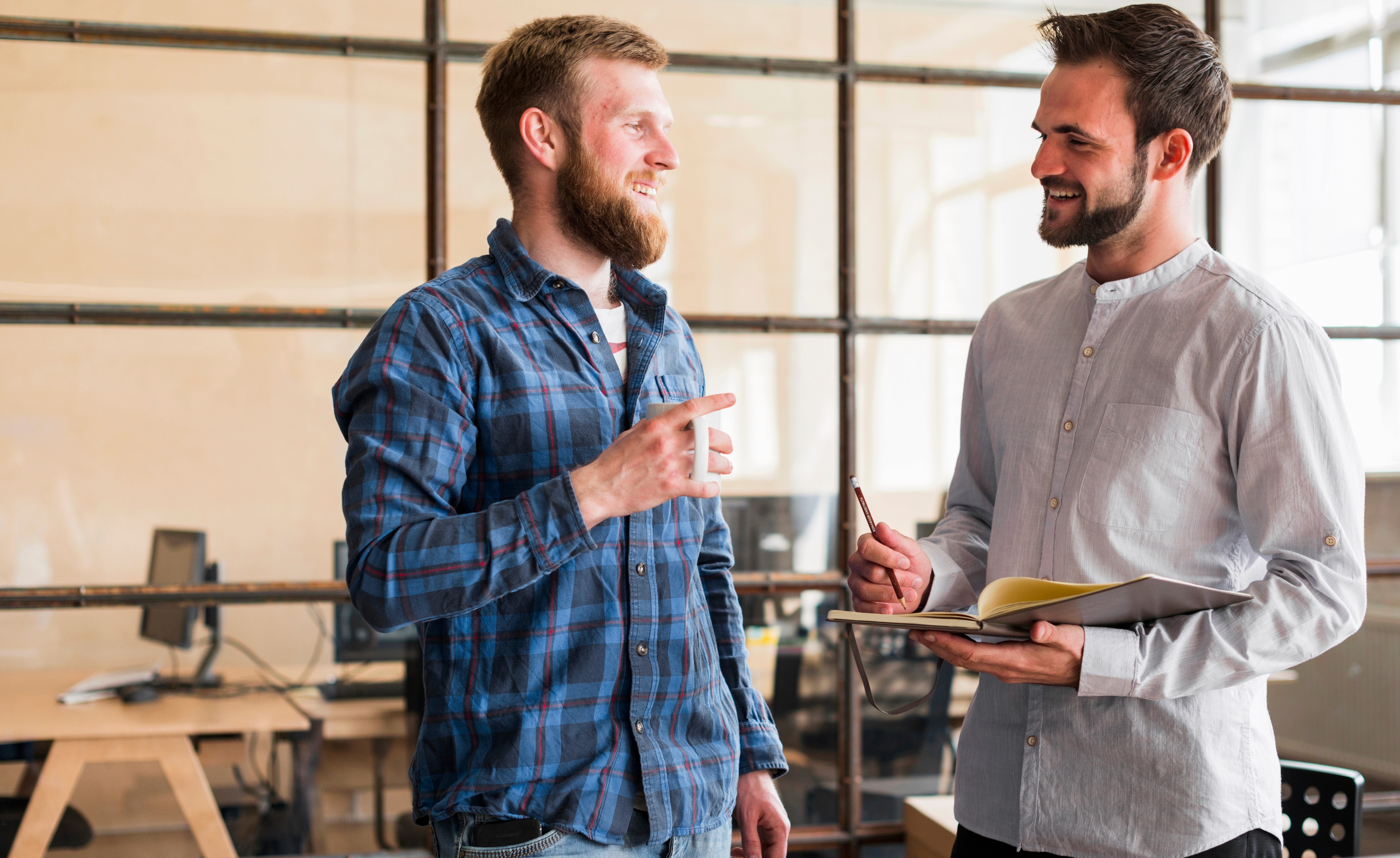 Two men discussing something on a tablet
