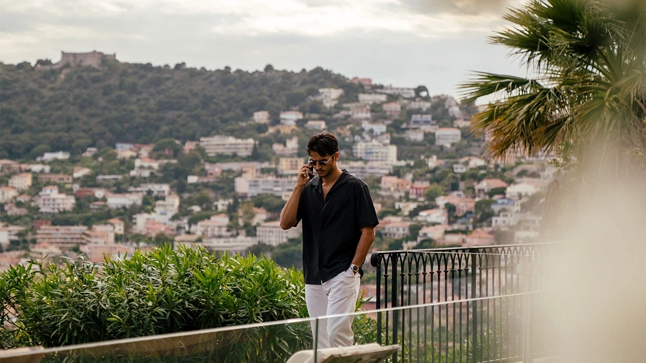 Luke Alexander taking a call overlooking the French Riviera