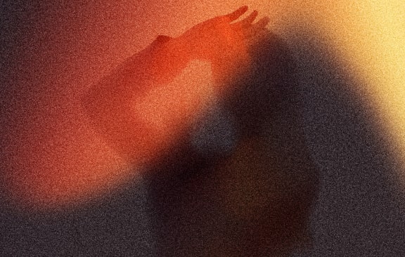 a person riding a snowboard on top of a sandy hill