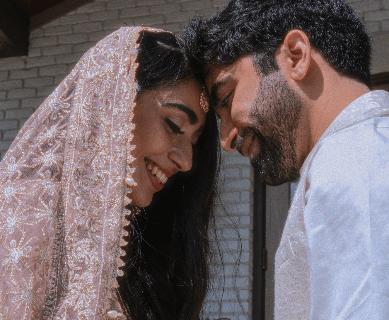 Newlyweds smiling at each other