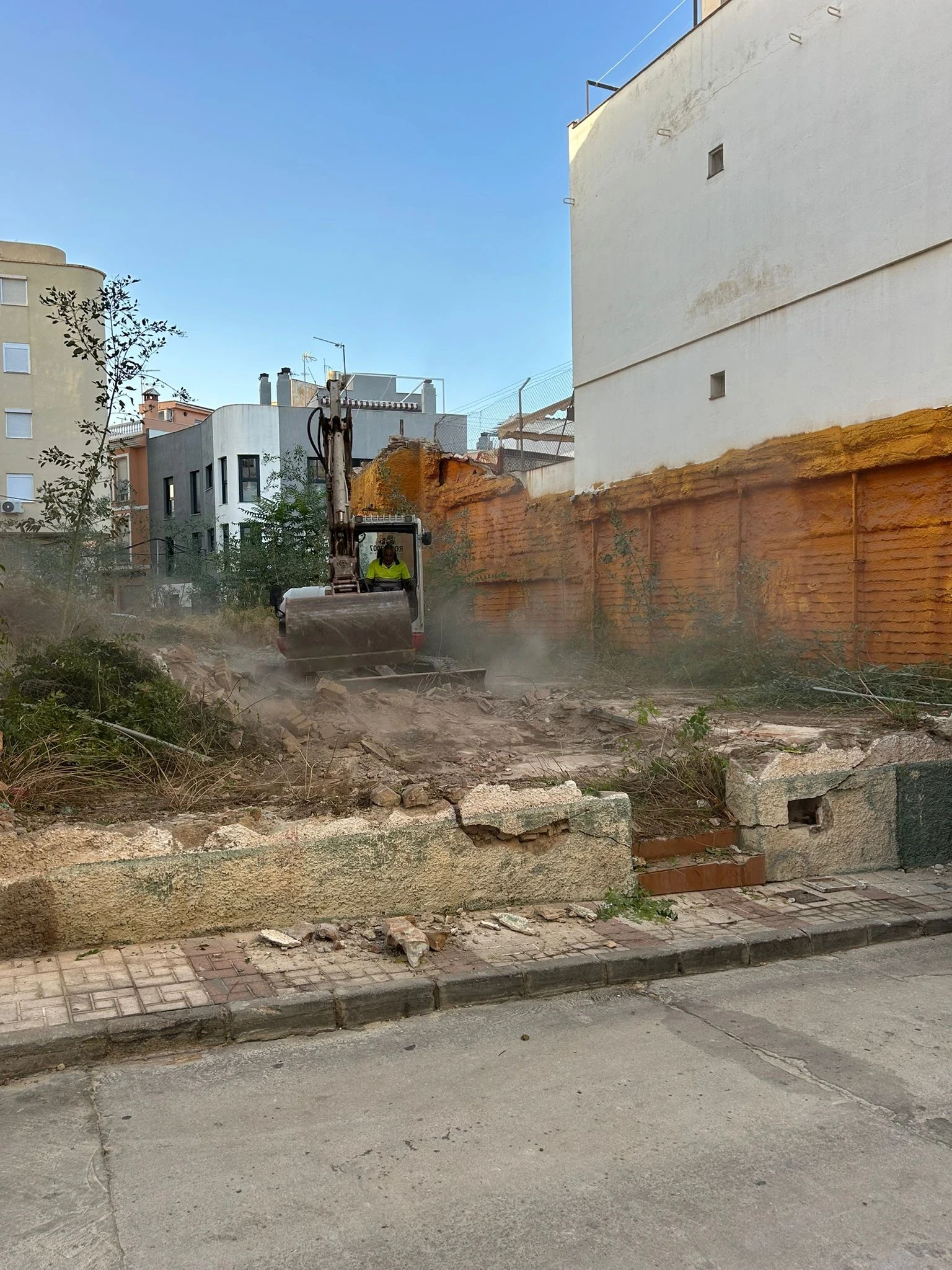 Construction site excavation at Calle Rodríguez 7, Málaga — groundworks and demolition phase of new-build boutique apartment building in the city centre
