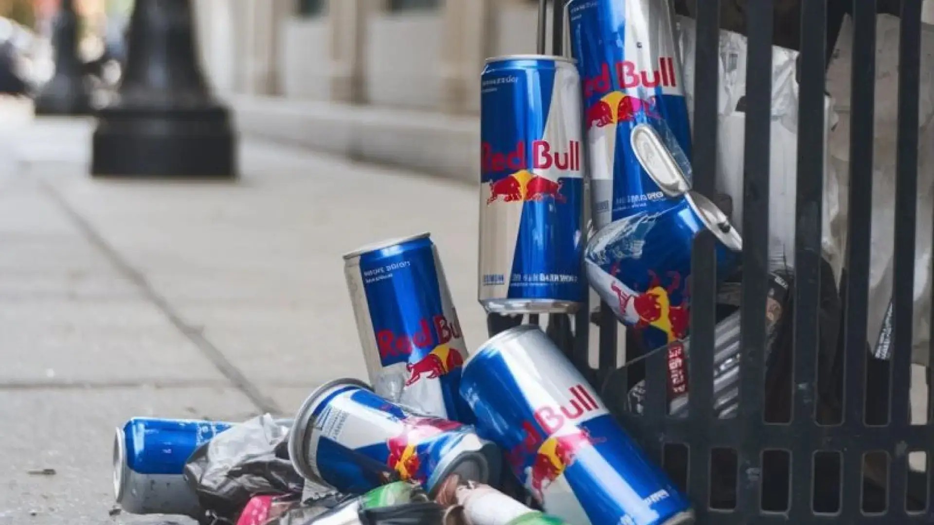 Discarded Red Bull cans placed near a trash bin, staged as part of the brand’s unconventional “trash marketing” stunt.