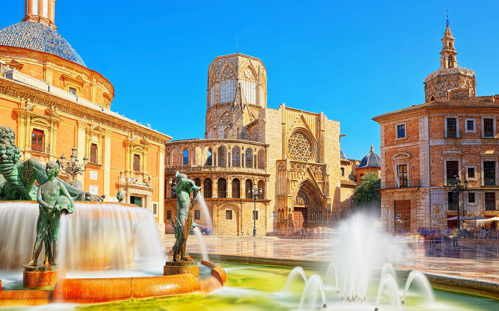 Valencia Cathedral and Turia Fountain on a sunny day during a self-guided audio tour.