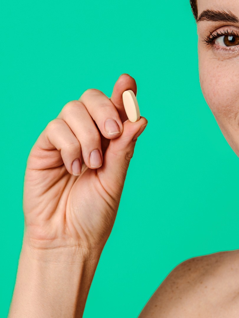 person holding brown and black round ornament