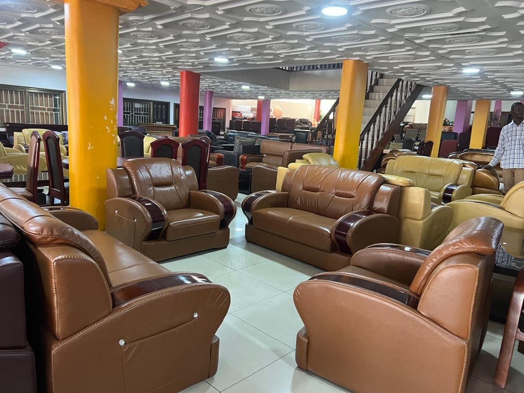 a gray couch with a wooden base on a gray background