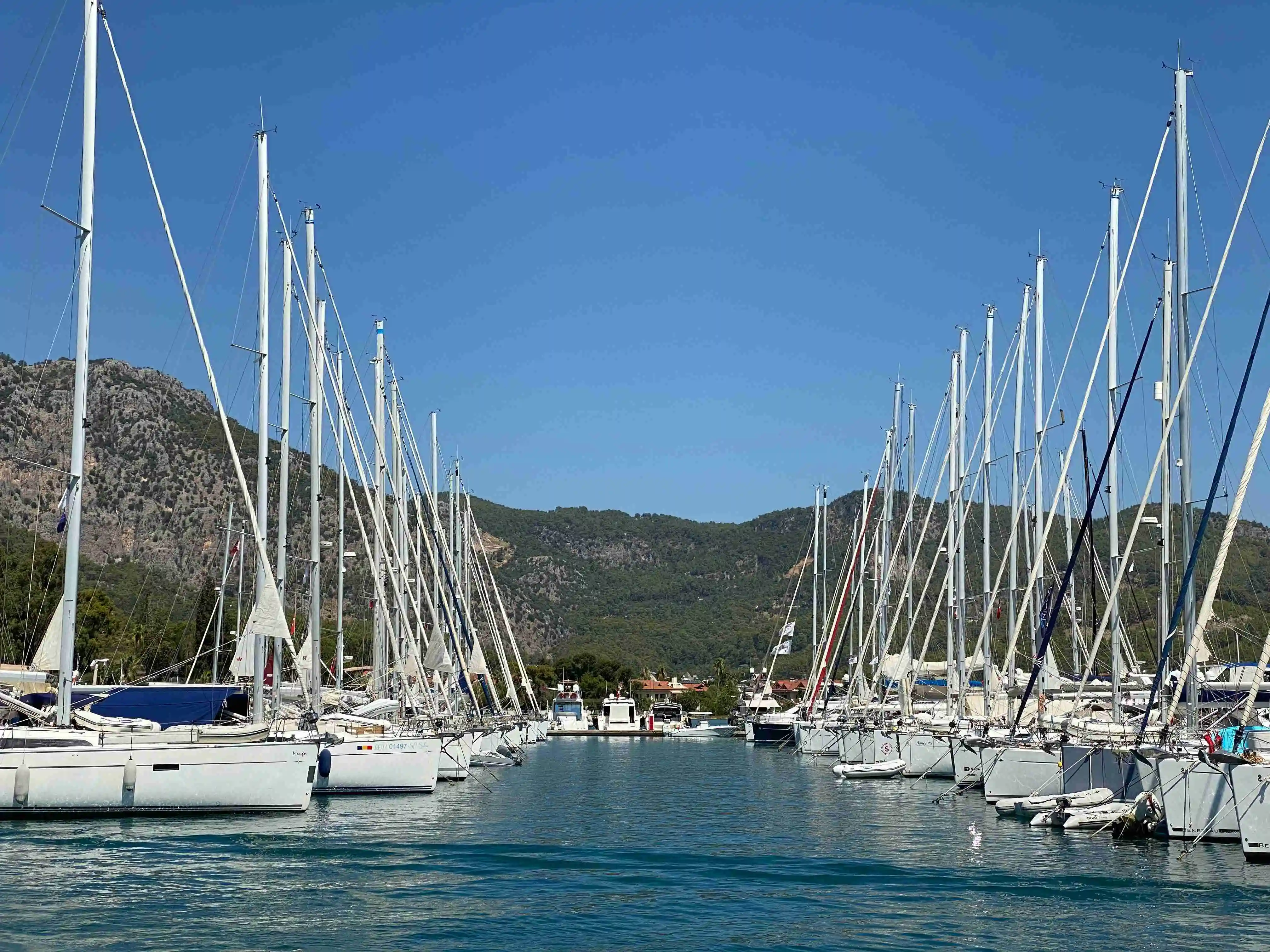 Yachts moored at Göcek Marina in Turkey before port authority inspections and maritime compliance procedures.