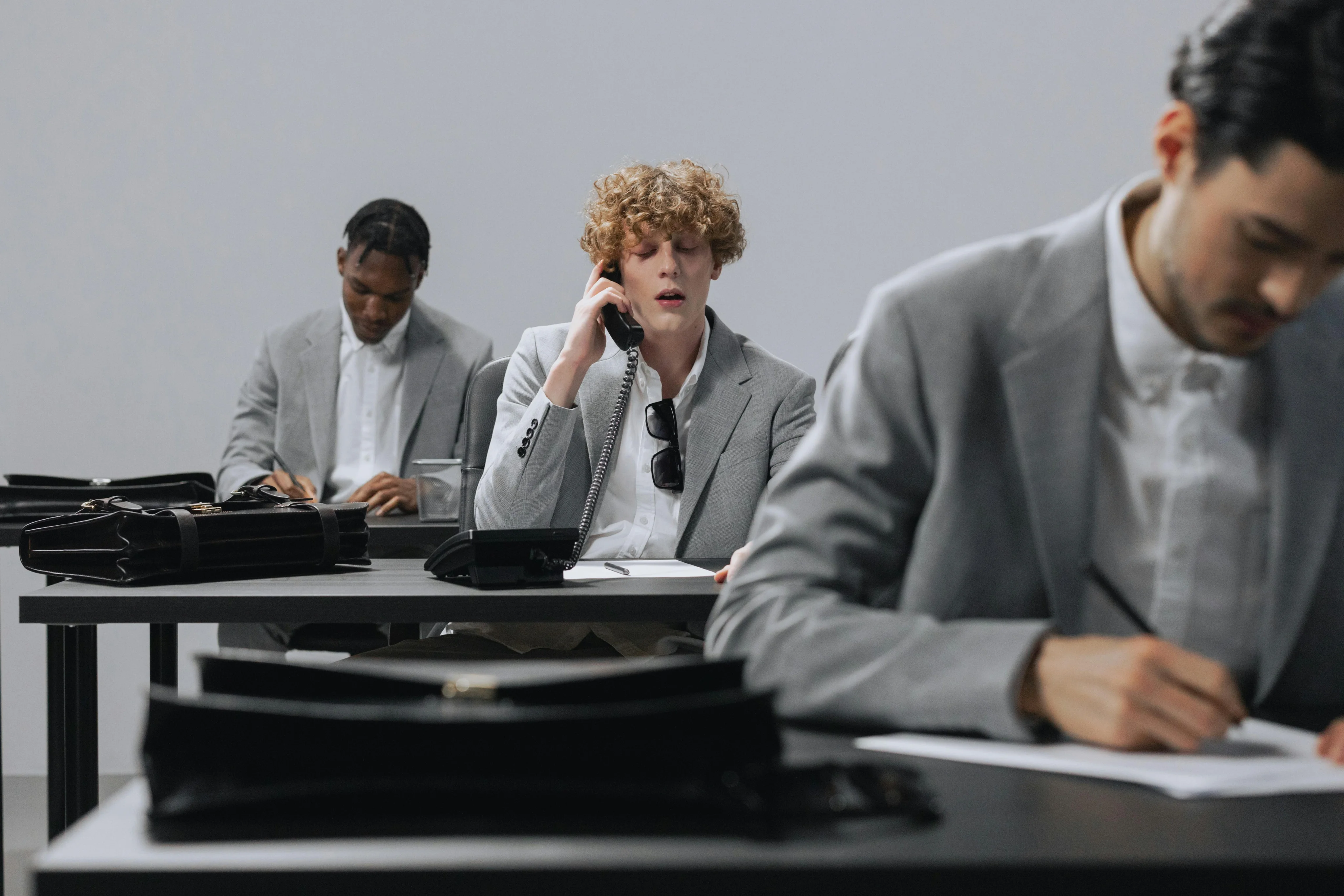 James Carter, Ethan Brooks & Chris Ford are sitting on desk