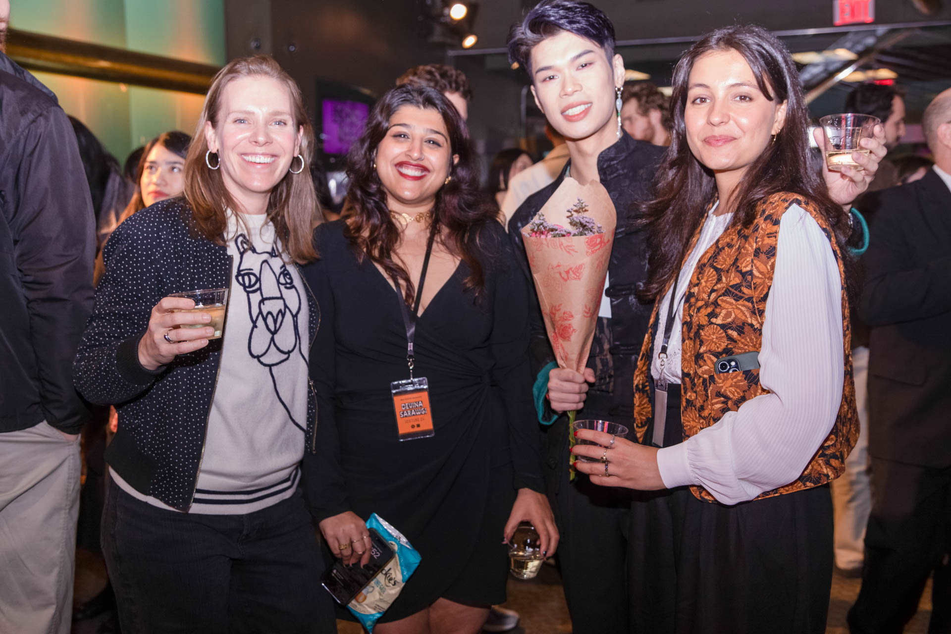 a group of students smiling for the camera in the SVA Theatre lobby after the Venture Forum