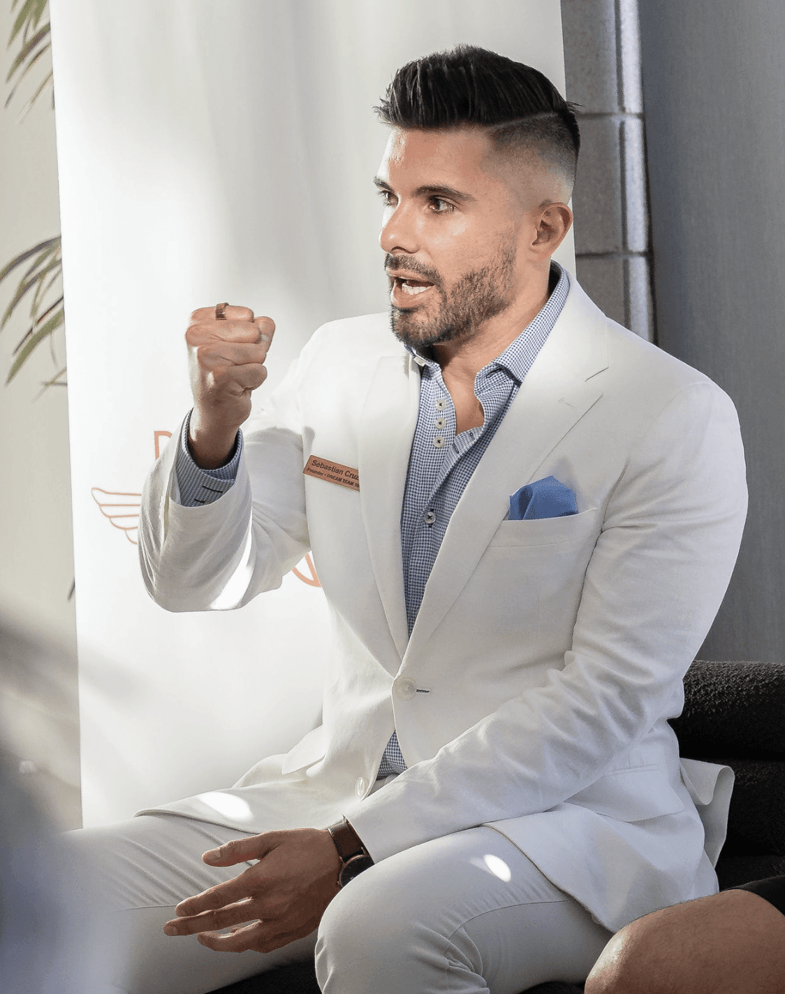 Black and white portrait of a smiling person with curly hair