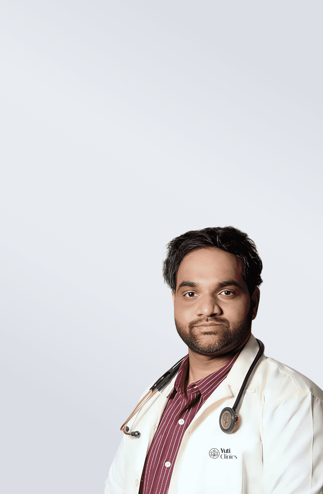 Close-up of lush, dark green leaves, some glossy and wet, against a muted background.