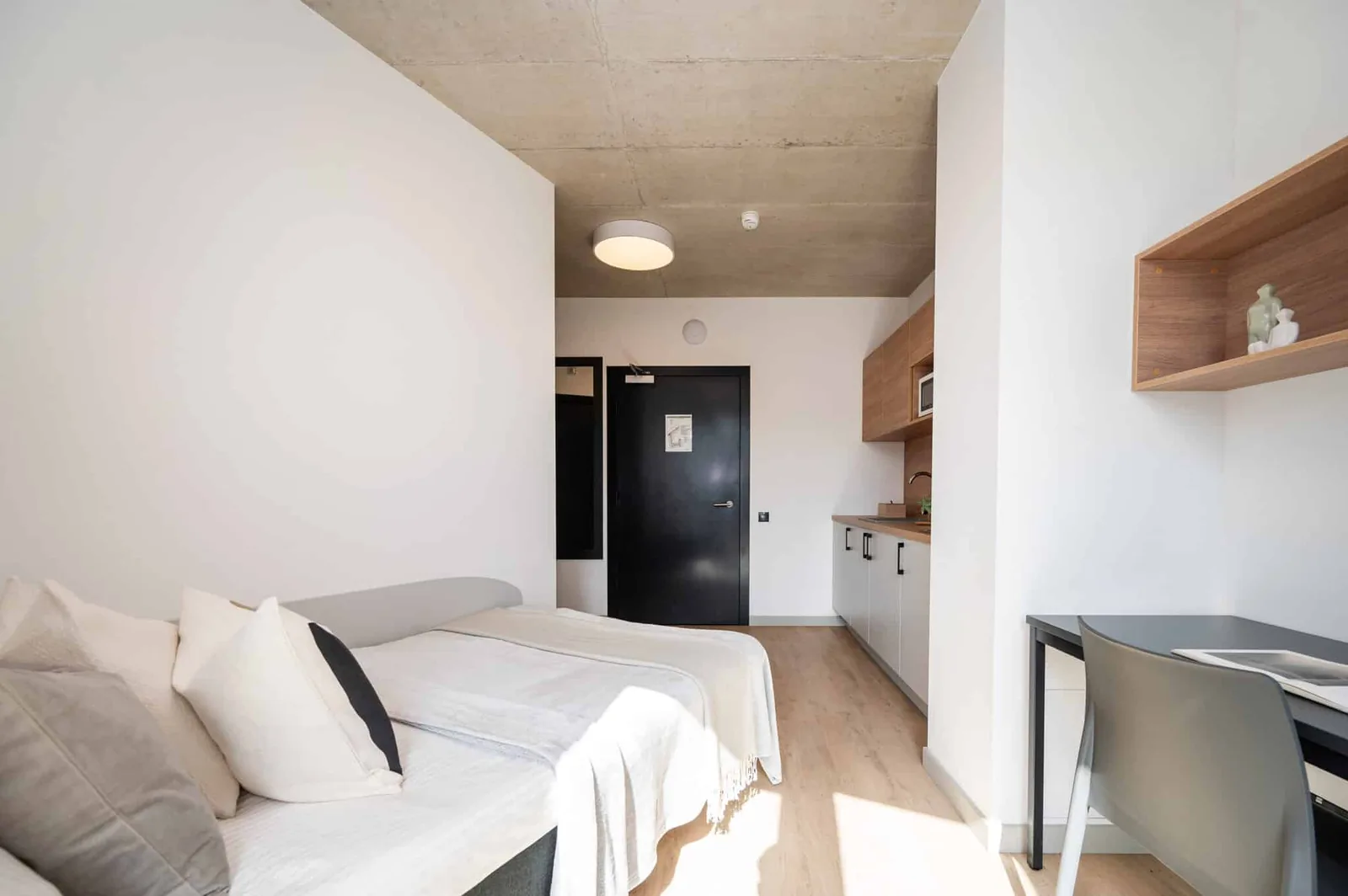 Private student bedroom in Riga with study desk, storage and modern studio furnishings