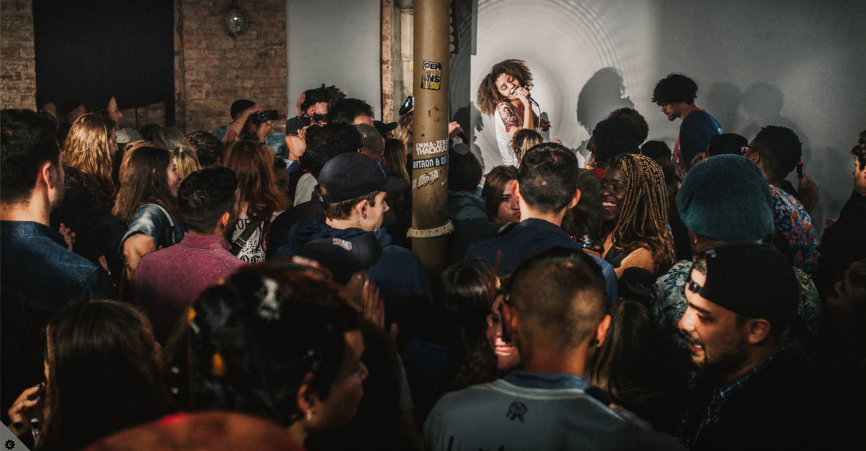 Crowd watching a live performance at a Root 73 event.