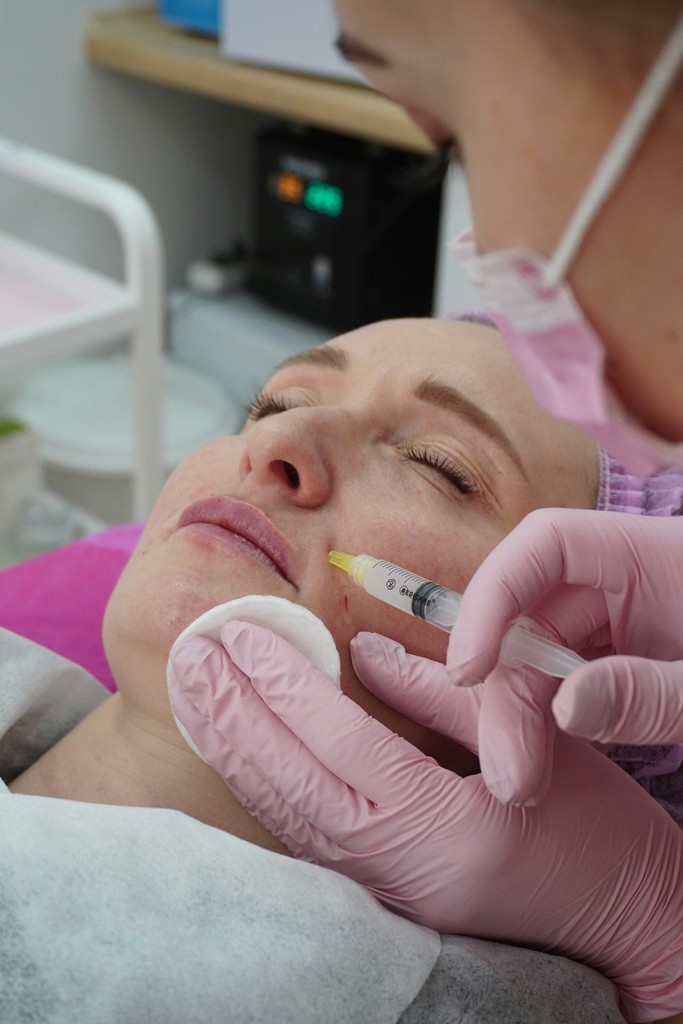 Patient comfortably lying down and relaxing while receiving a Botox injection at a medical spa in Delray Beach, Florida.