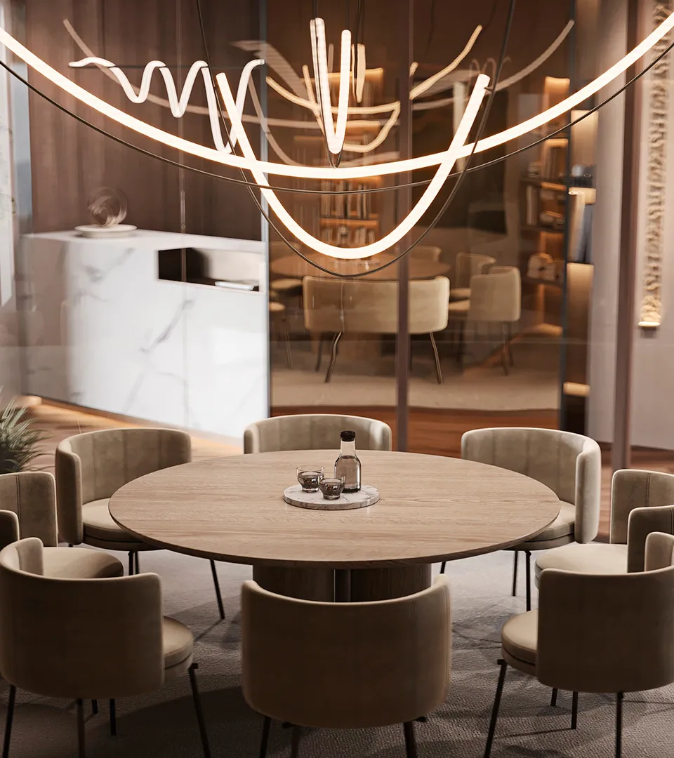 City Studio Zurich office collaboration area with round table seating and sculptural pendant lighting