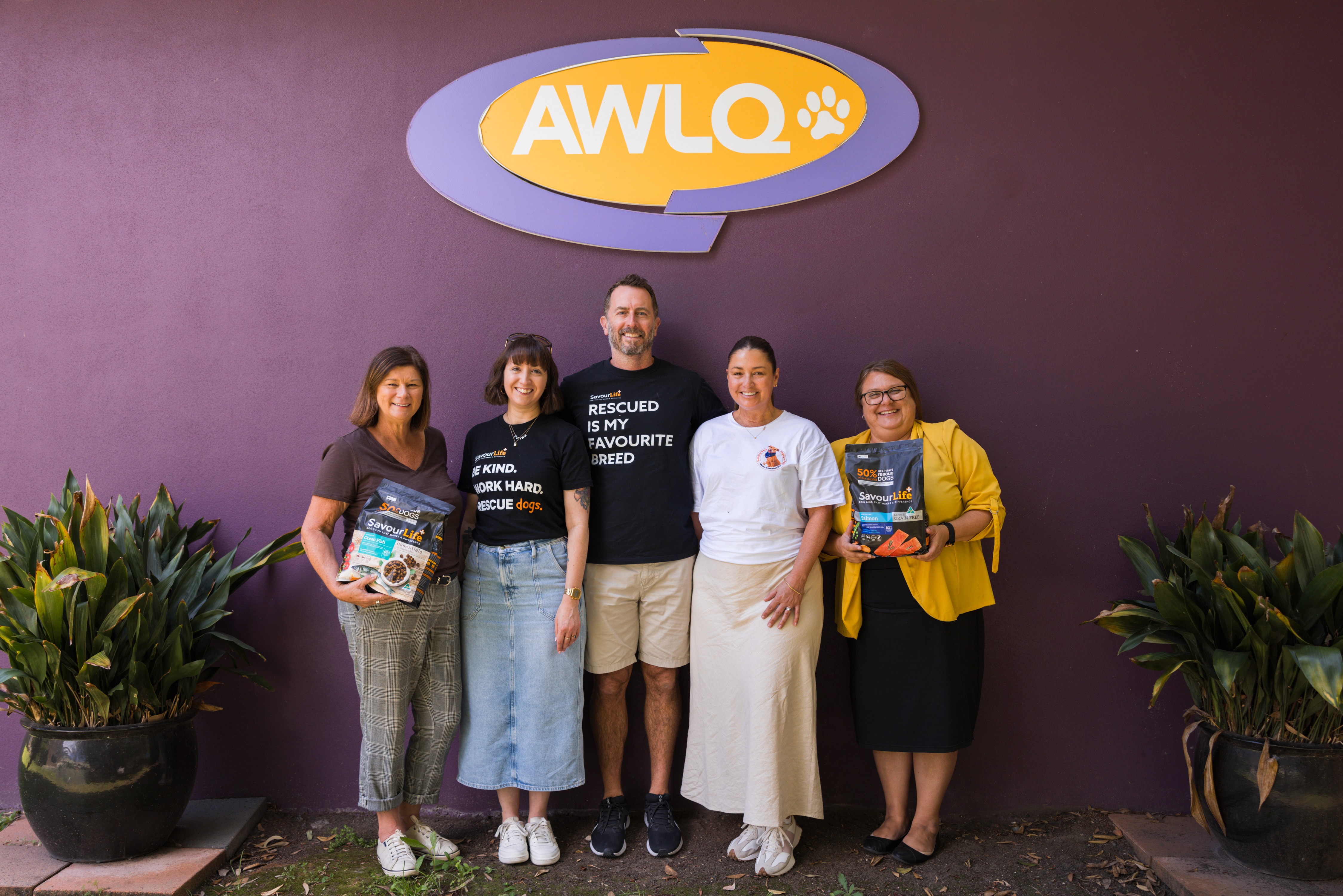 Group portrait in front of purple wall
