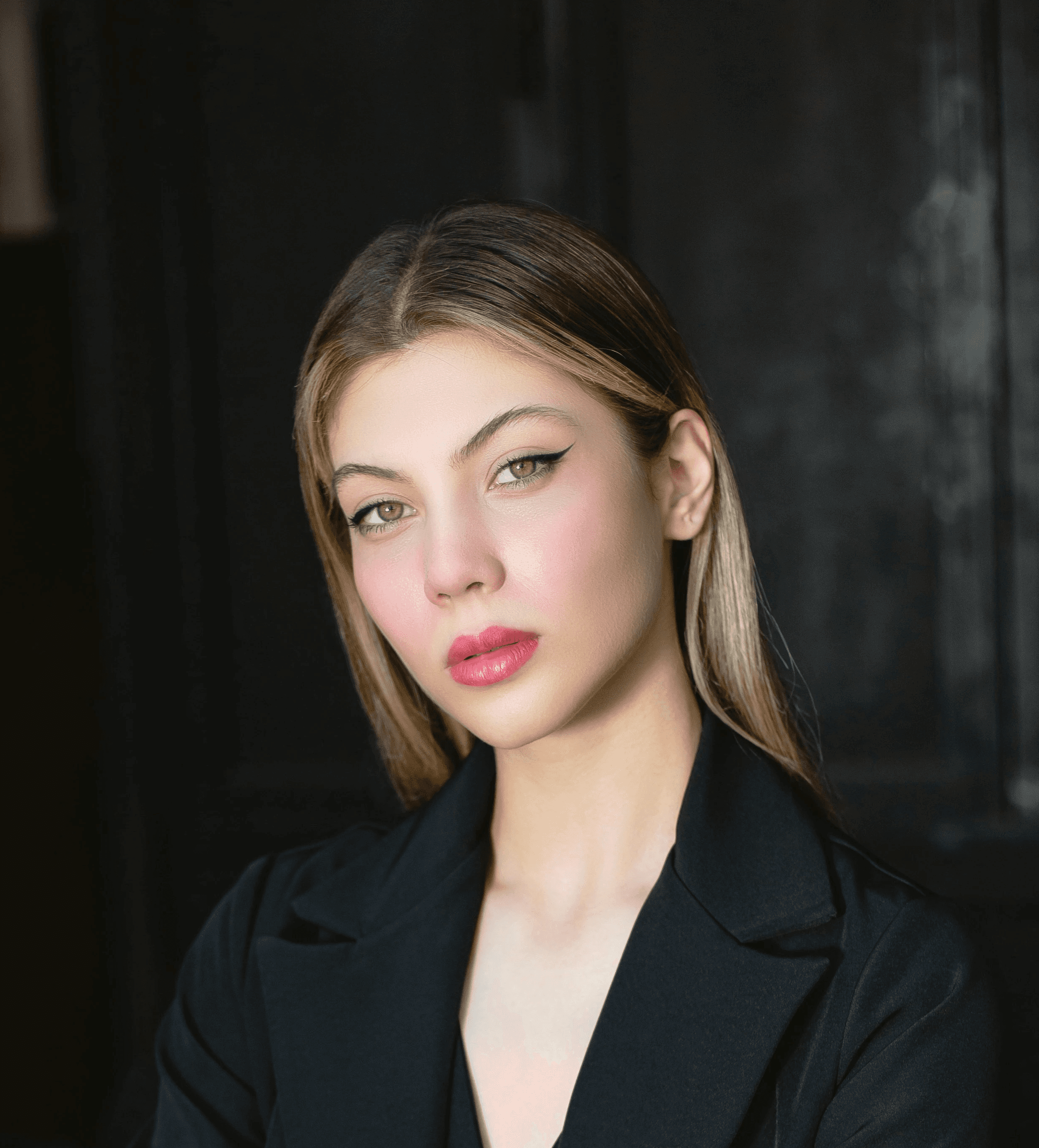a woman sitting at a table with a drink in her hand