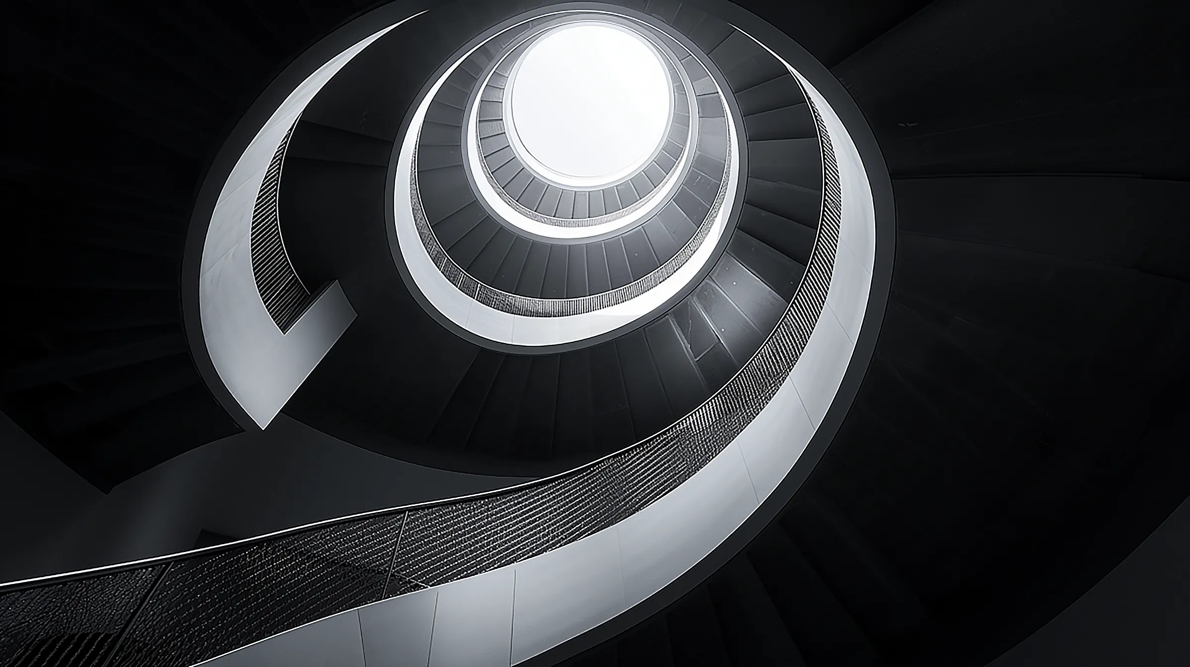grayscale photo of spiral staircase