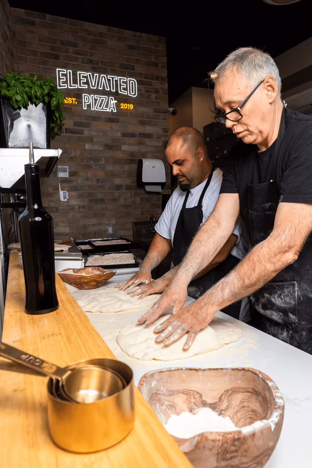 Elevated Pizza brand photography featuring people in a professional setting visual presentation