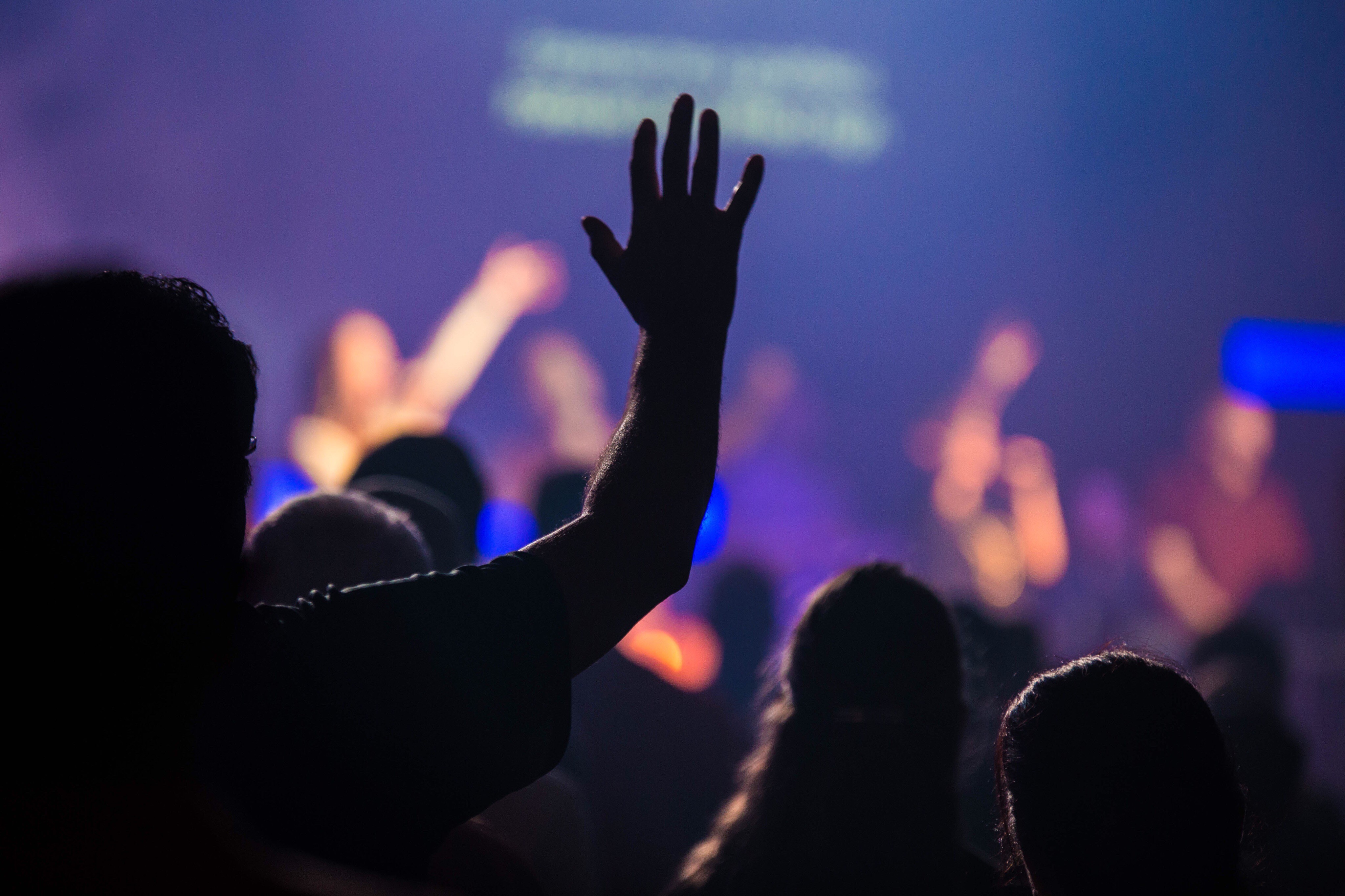 five children smiling while doing peace hand sign