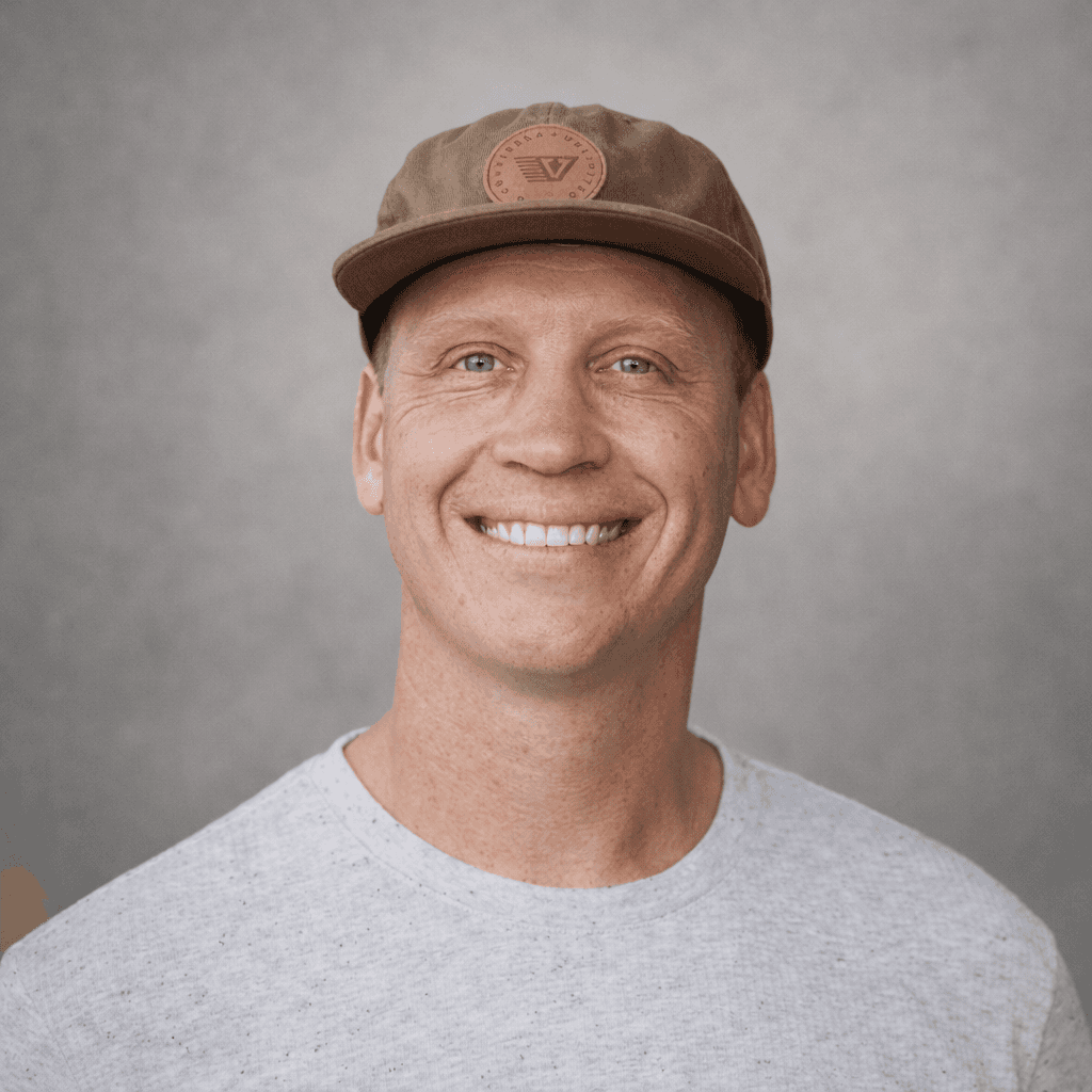 Black and white portrait of a smiling person with curly hair