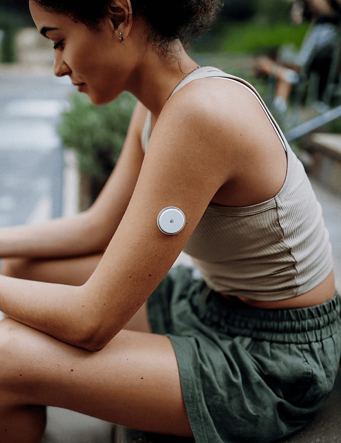 Woman wearing a continuous glucose monitor for metabolic health screening and personalized longevity testing.