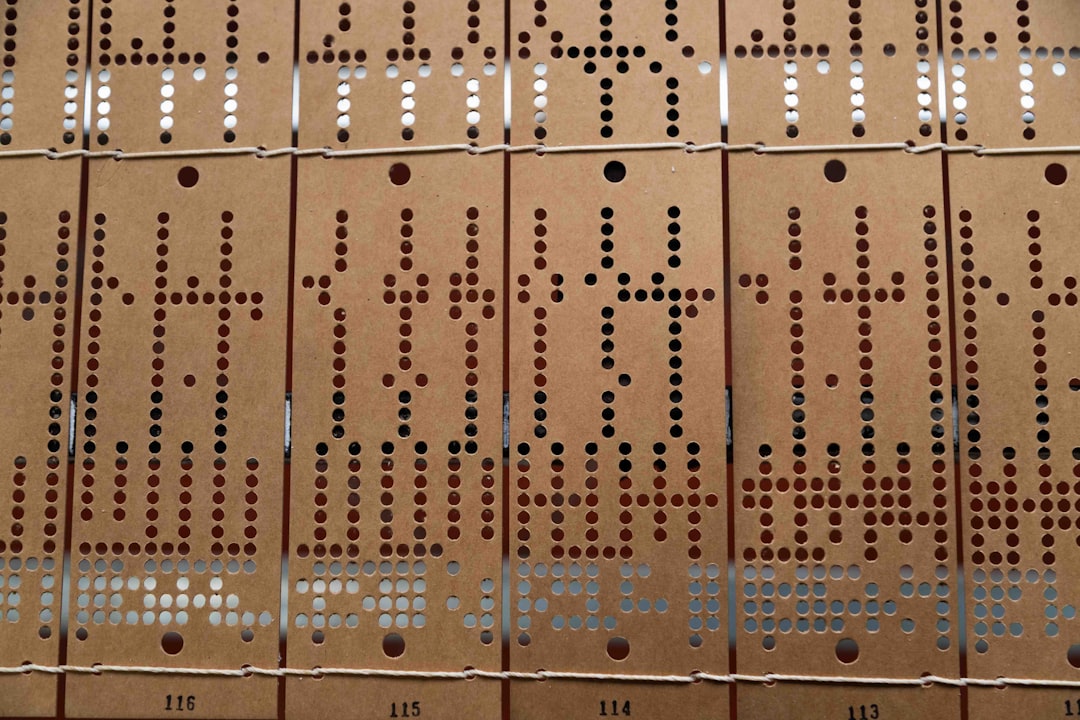 A close-up of old punch cards with holes