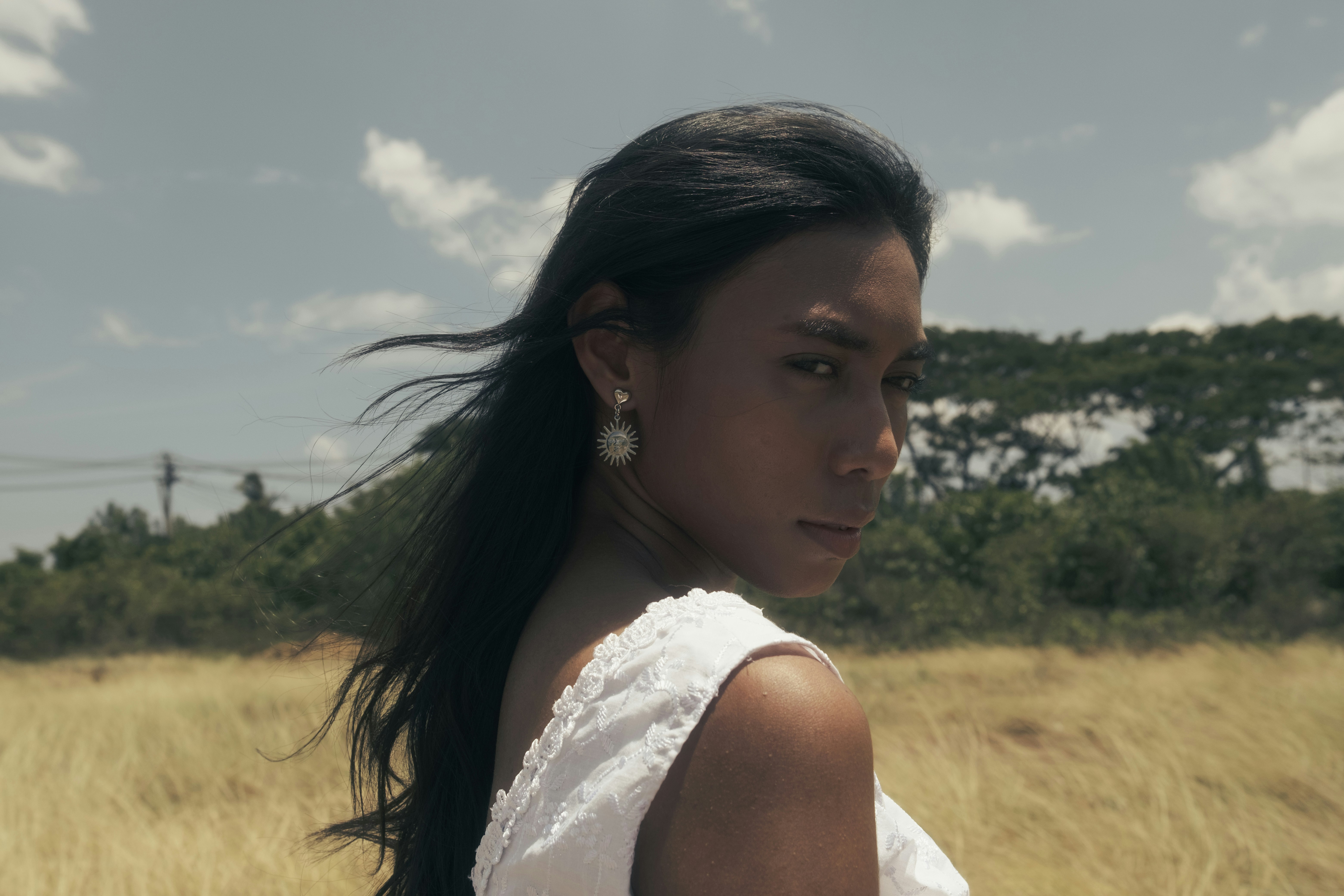 A woman standing in a field of tall grass