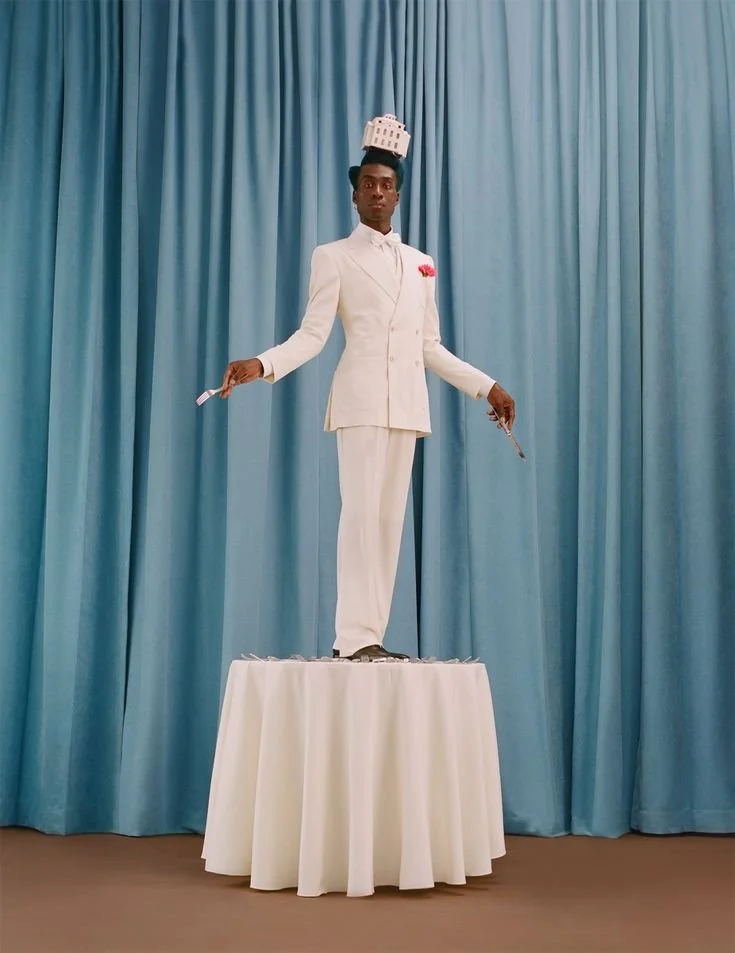 Playful, surreal image of a person standing on a small table, symbolising confidence and creative expression