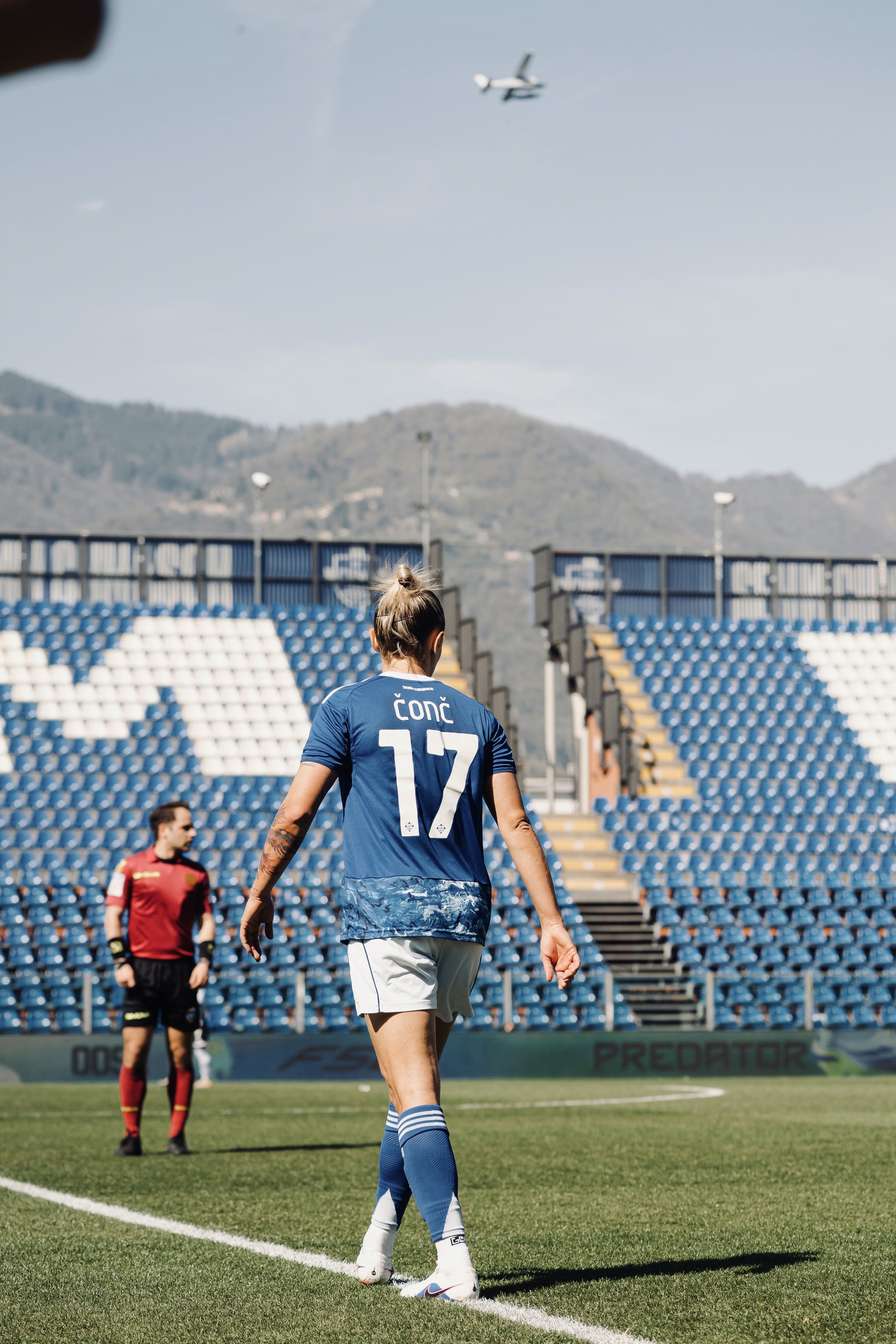 Rachel, personal trainer, looking to the side confidently in a fitness studio