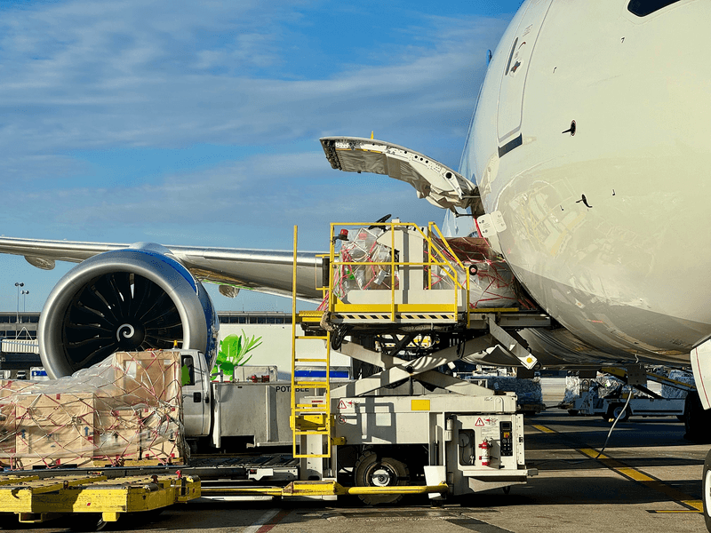 An aeroplane being filled with cargo