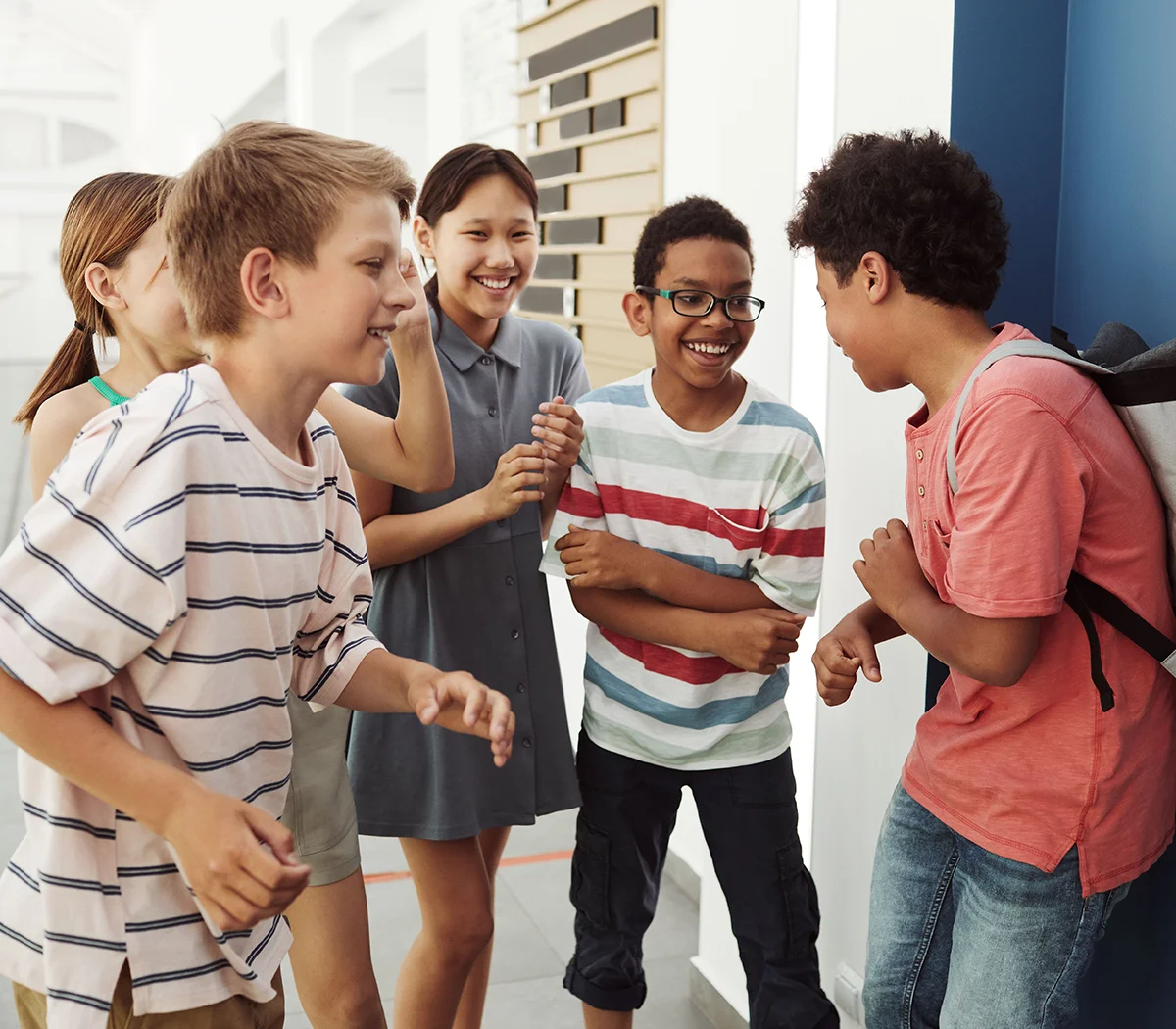Group of school aged children laughing together.