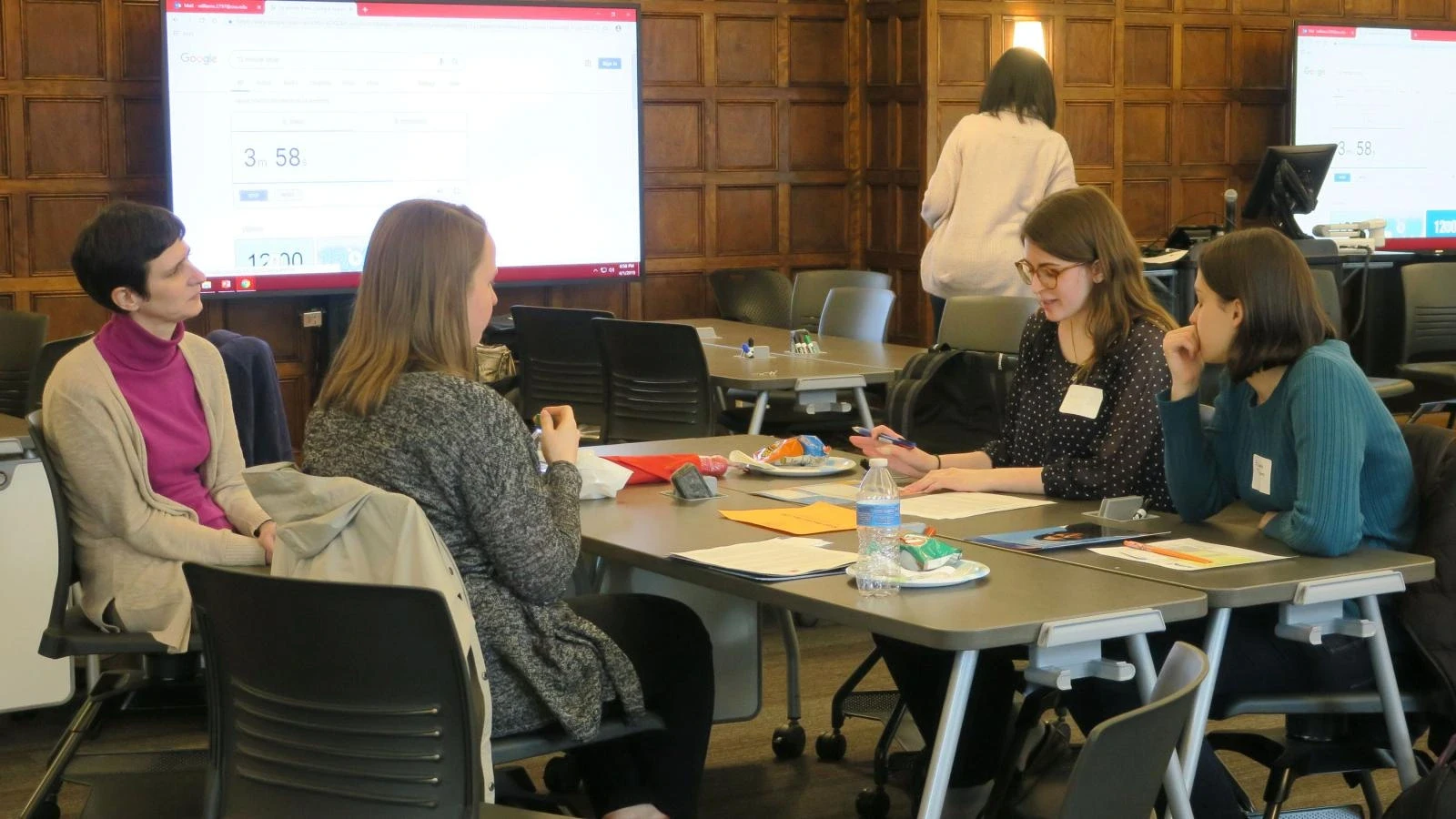 High school students collaborating on STEM and law projects during RISE Research summer programs with Ivy League mentorship in a dynamic classroom setting.