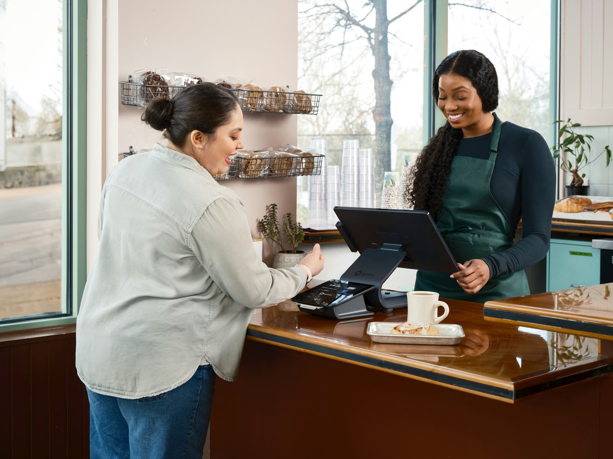 Small business owner taking a card payment at a shop counter