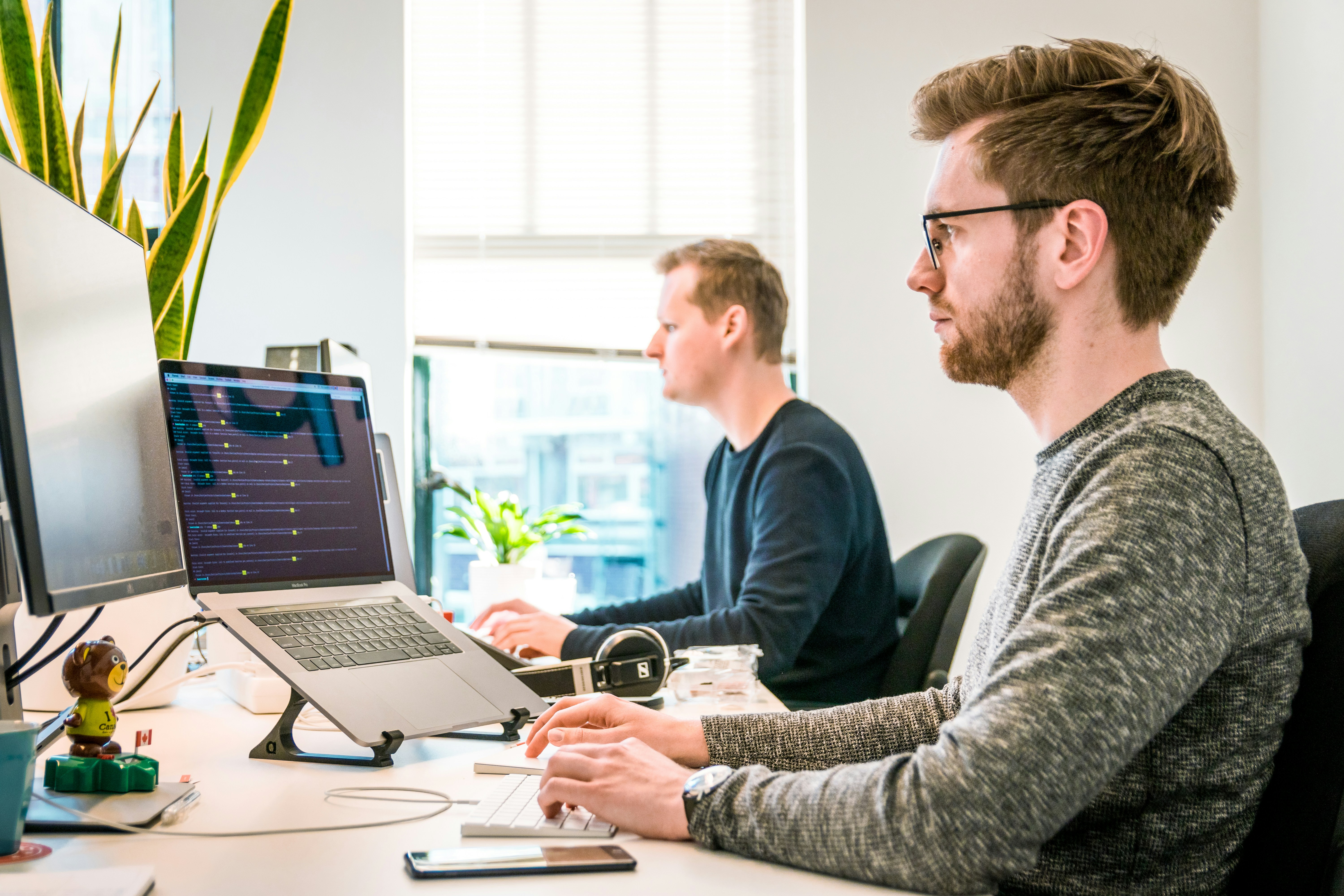 man with friend working on AI for Administrative Tasks